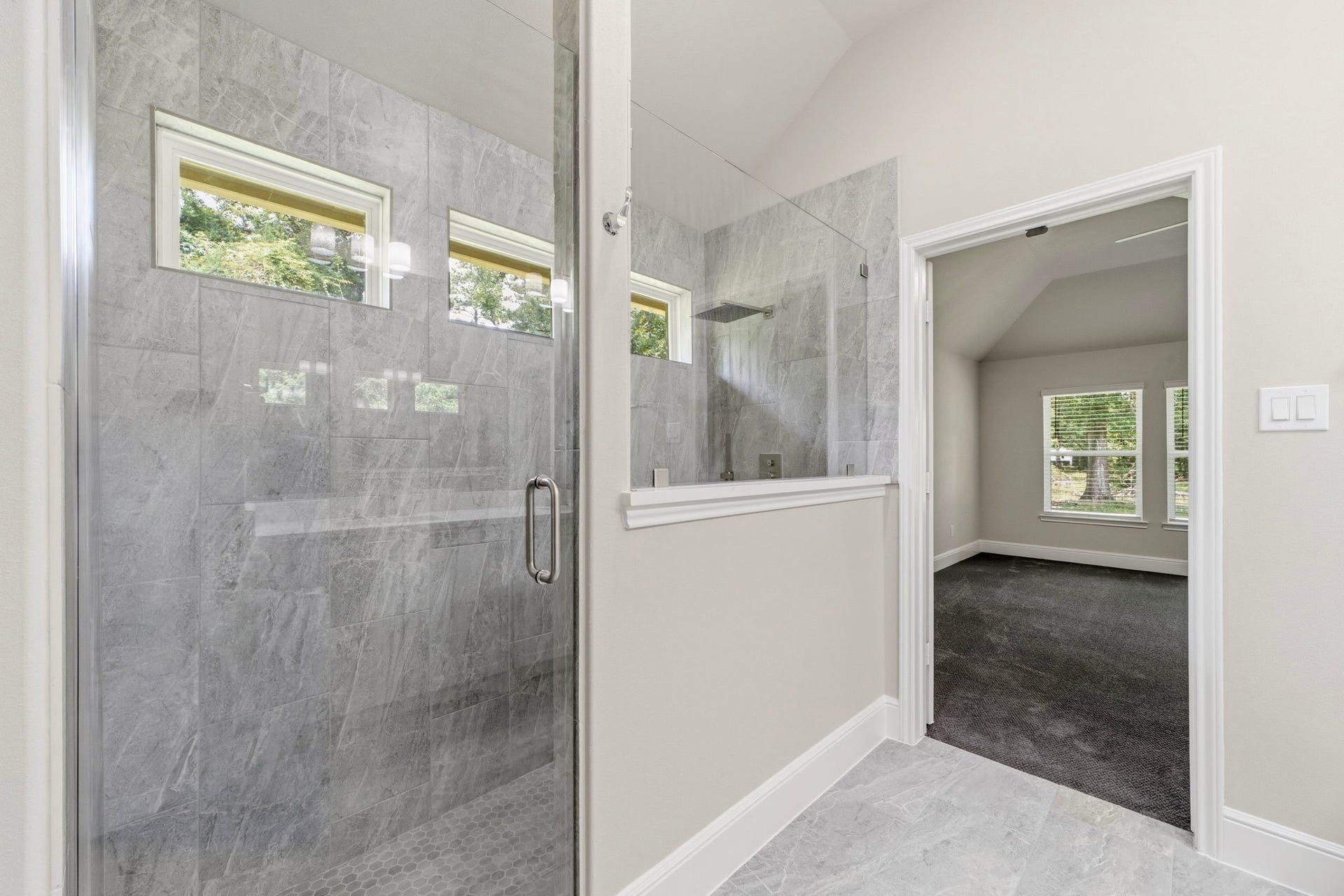 23620 Youpon Lane, Spring, TX 77389 Luxurious walk in shower with elegant tile surround and sleek glass enclosure