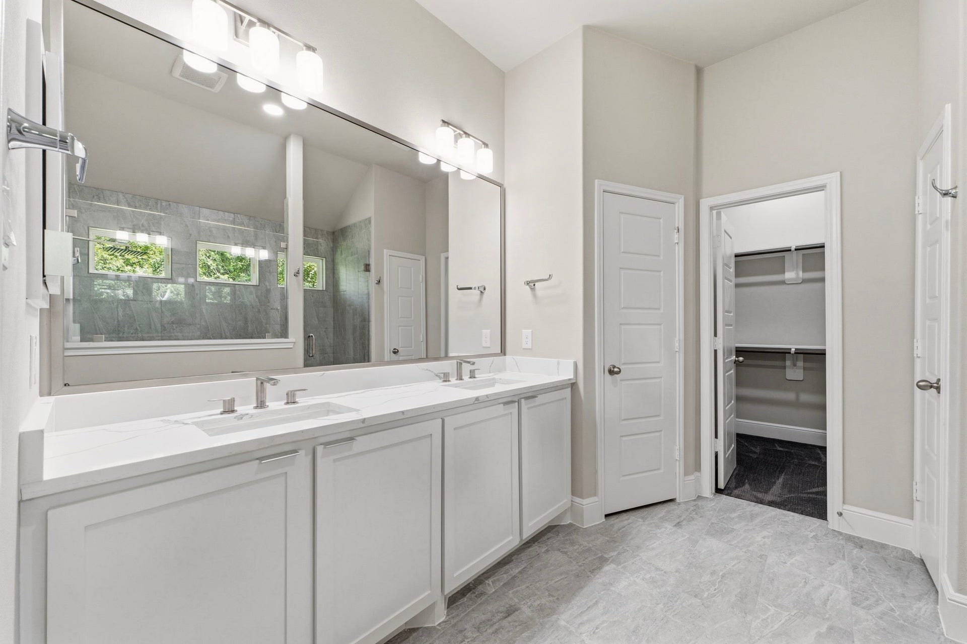 23620 Youpon Lane, Spring, TX 77389 Spa inspired primary bath with dual sinks, quartz countertops, and a walk in closet