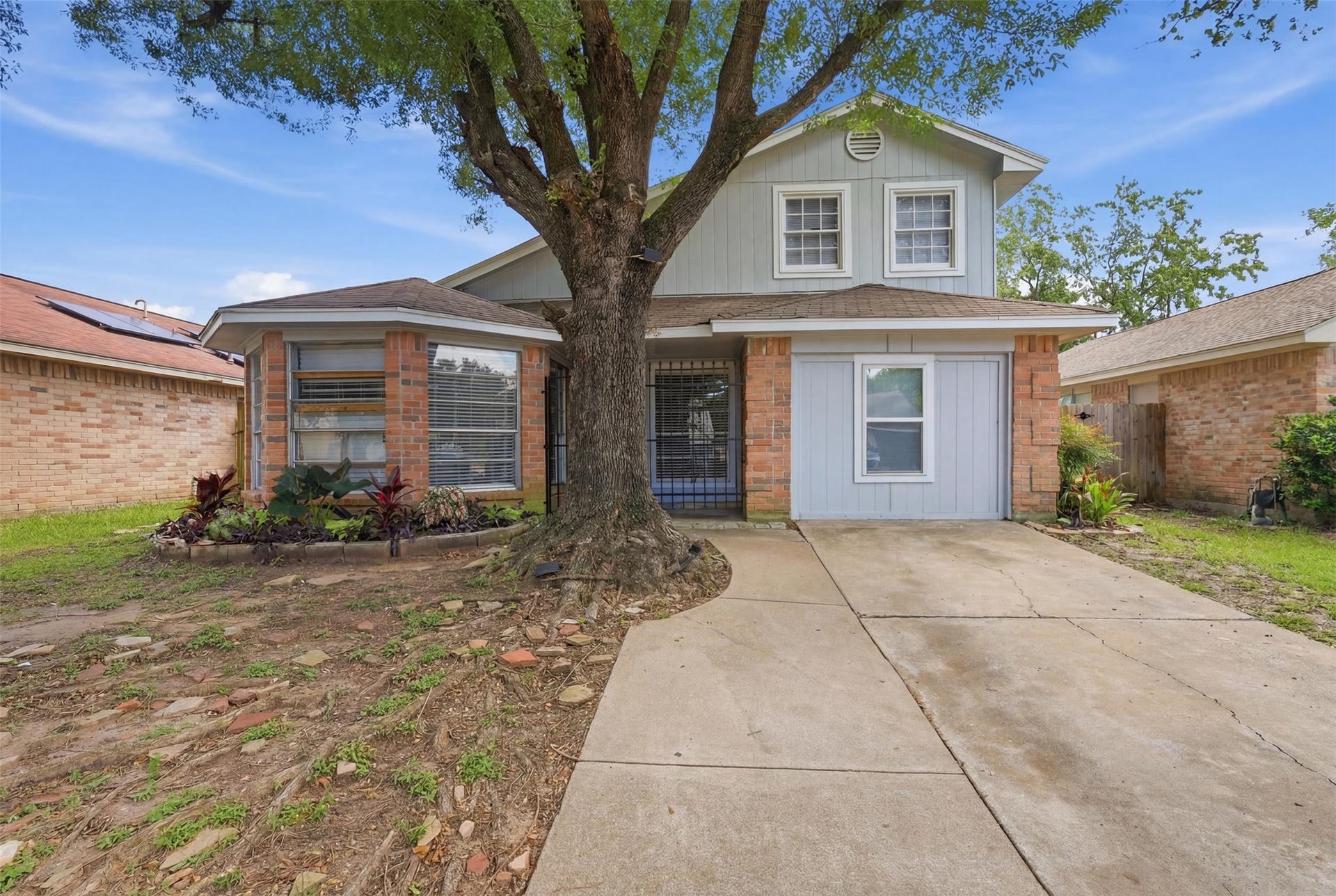 3831 Derbyhall Drive, Houston, TX 77066 Charming brick exterior with mature shade trees and inviting curb appeal.