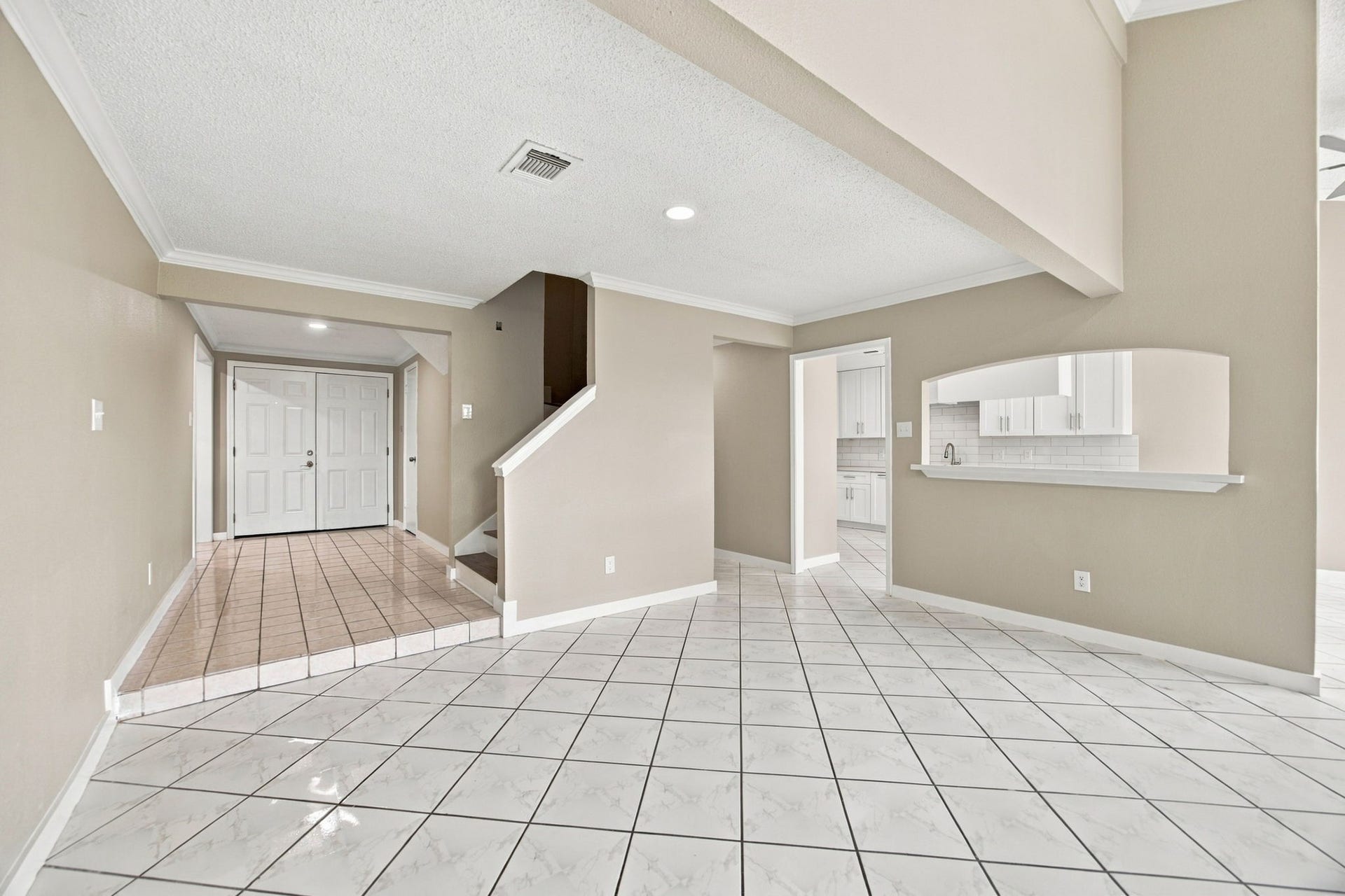 Partial high-ceiling creates a dramatic elegant living space