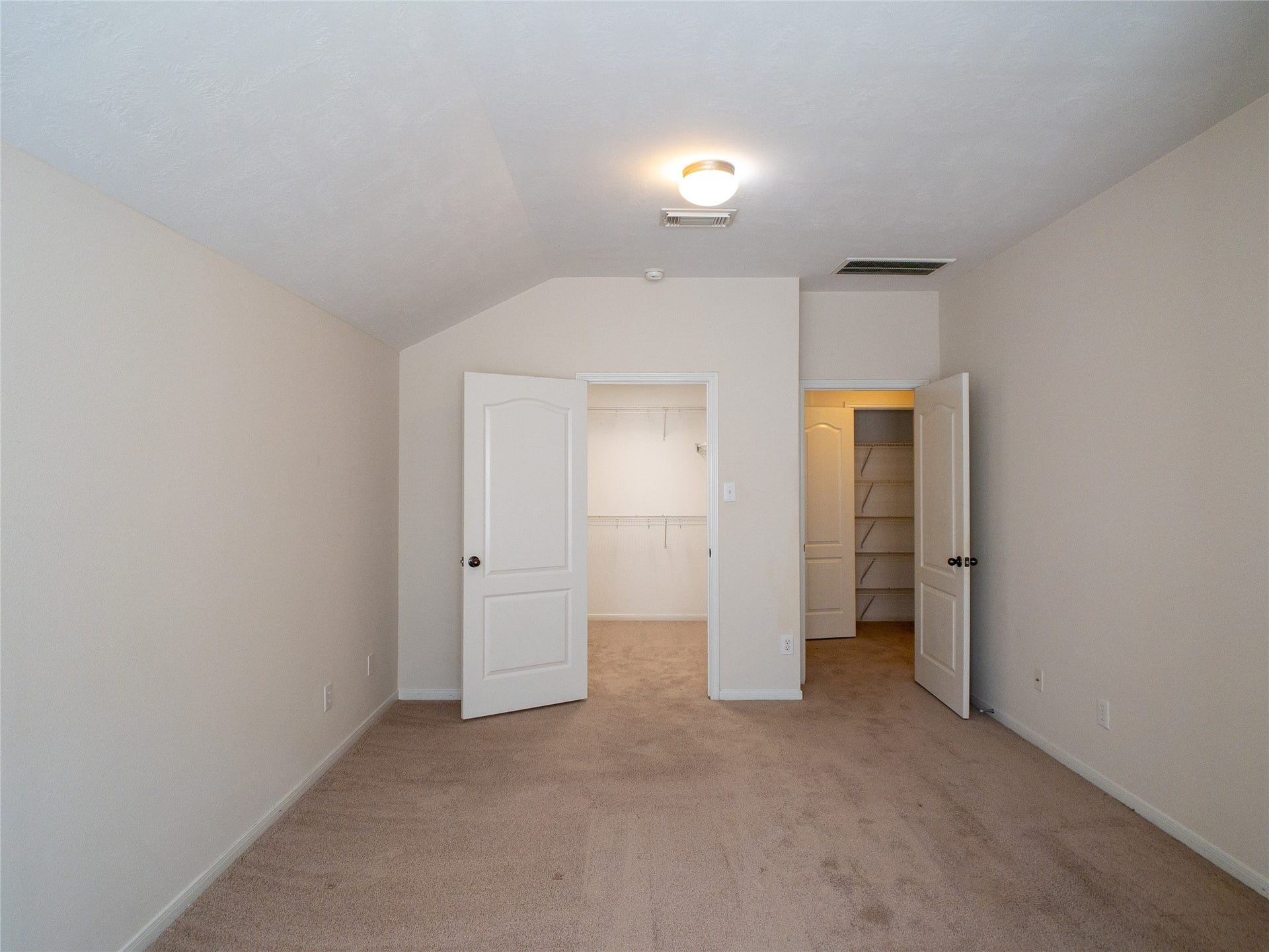 5406 Timber Court Hollow, Houston, TX 77084 reverse view of primary bedroom with primary closet; 2nd-floor landing/linen closet can be seen through the door to the right
