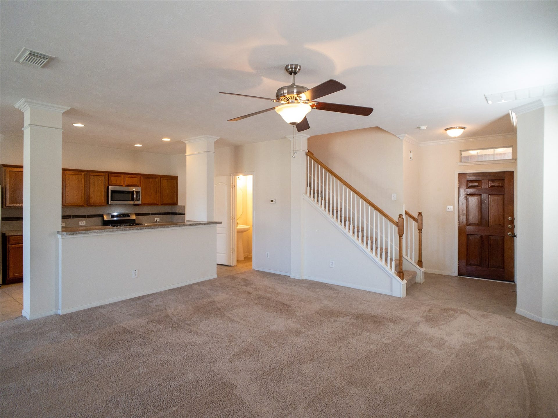 5406 Timber Court Hollow, Houston, TX 77084 another view of living room with kitchen/breakfast bar and powder room