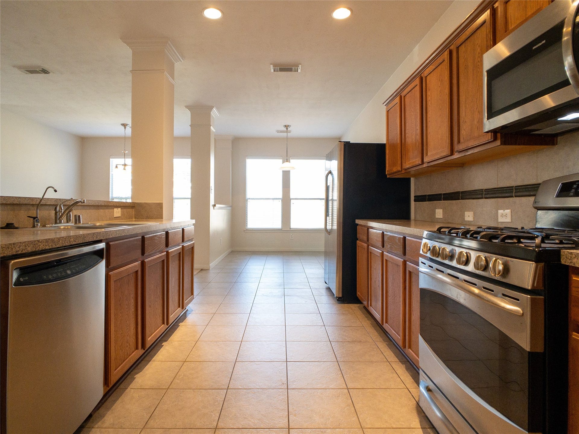 5406 Timber Court Hollow, Houston, TX 77084 reverse view of kitchen: nice Formica countertops, tile backsplash