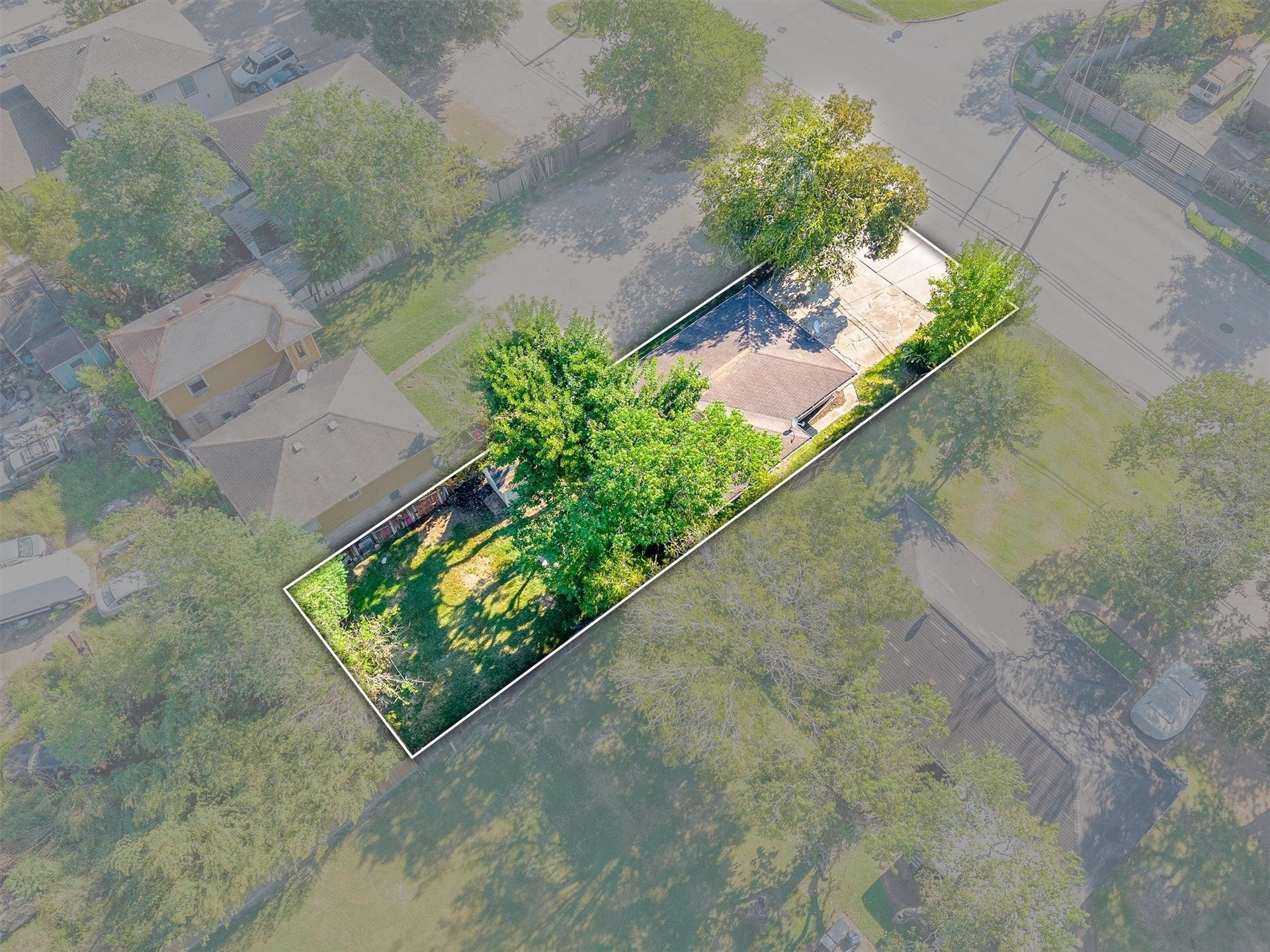 3218 5th Street, Stafford, TX 77477 This aerial view highlights the spacious, fully fenced backyard, showcasing the ample outdoor space and privacy the property offers.