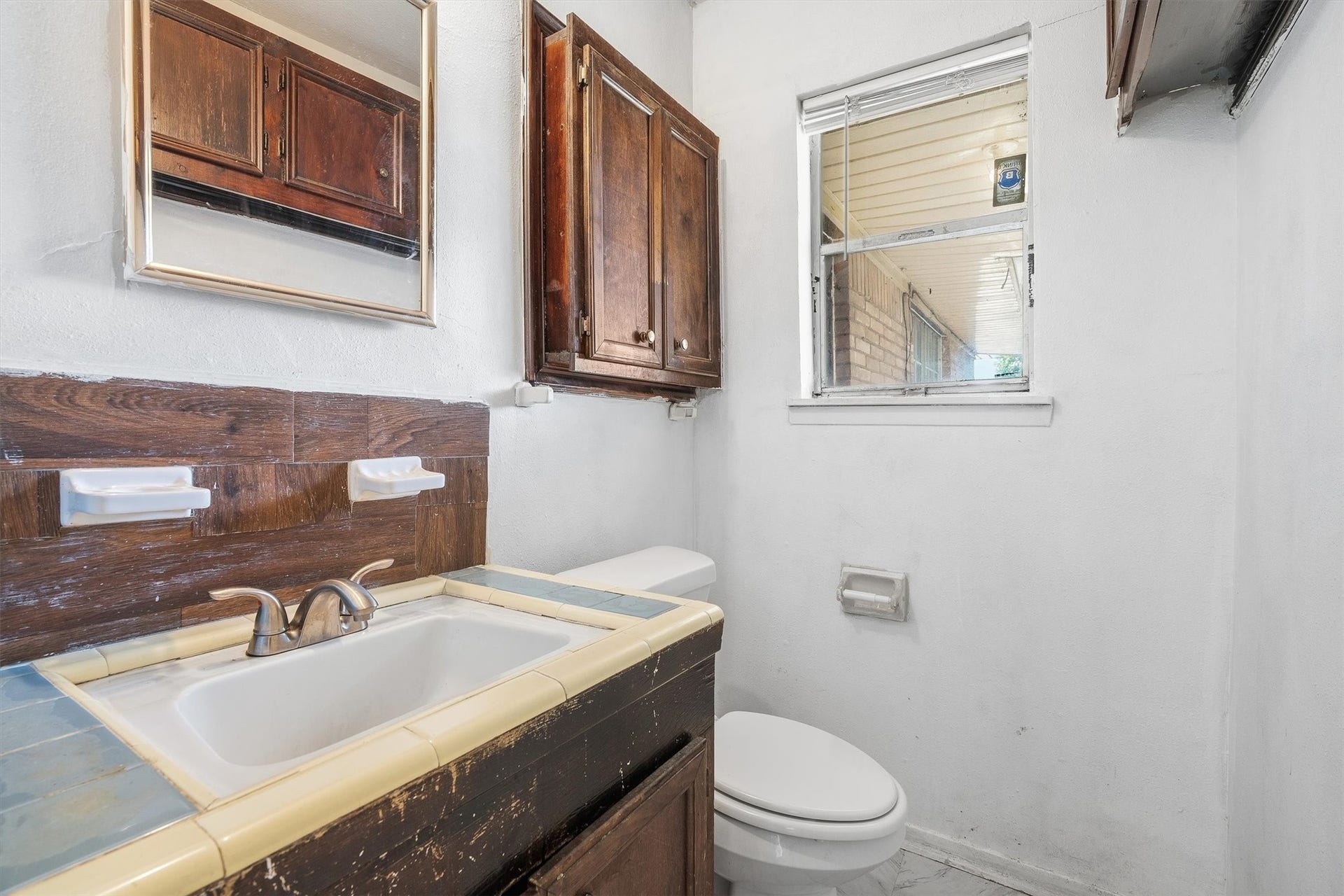 3218 5th Street, Stafford, TX 77477 The convenient half bathroom features a toilet and single-sink vanity, offering a great opportunity to add your personal touch and create a refreshed space that suits your style!