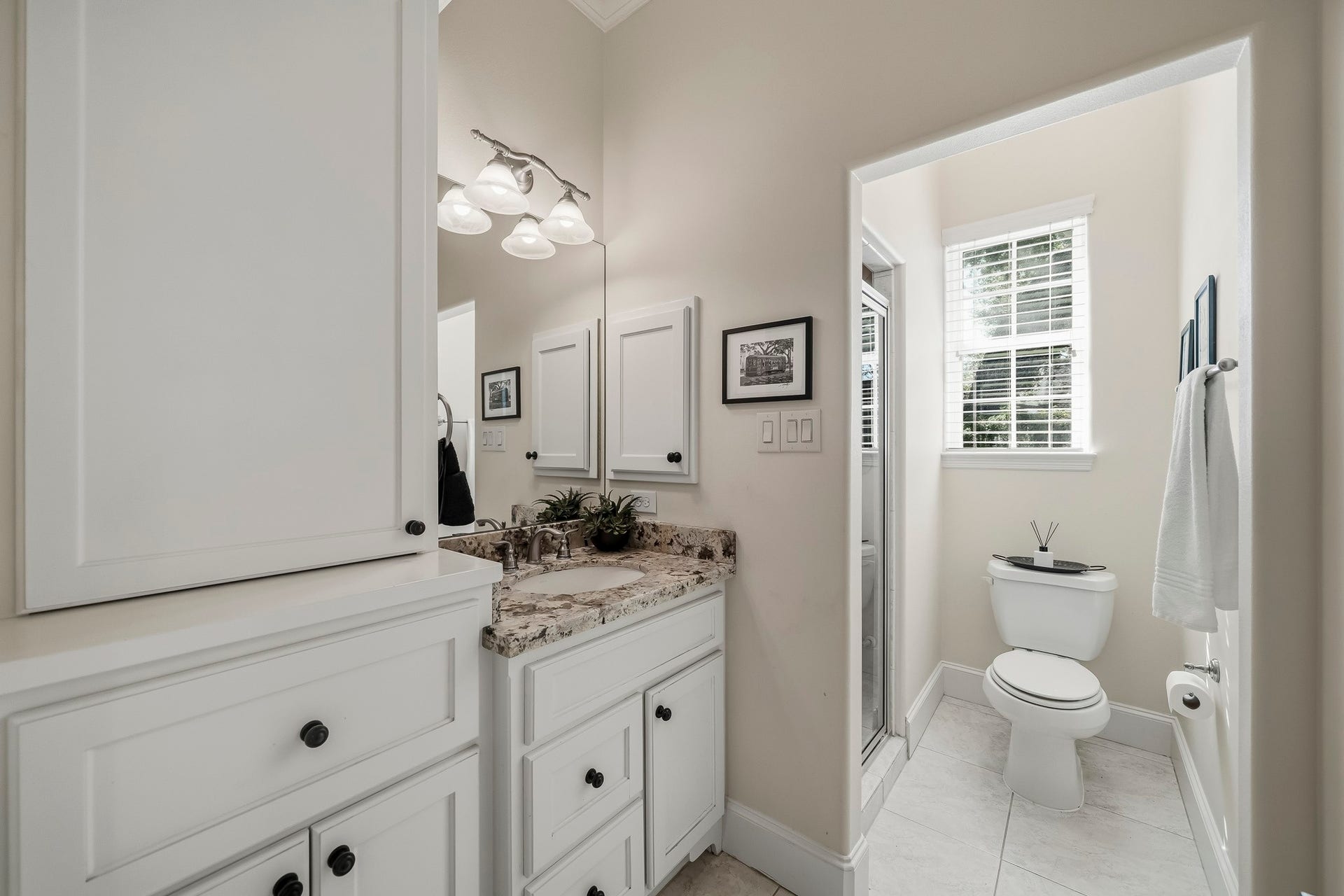4631 Lake Village Drive, Fulshear, TX 77441 Conveniently shared by both Secondary Bedrooms, this spacious Secondary Bath combines timeless finishes with everyday practicality. An elegant granite-topped vanity with an undermount sink and medicine cabinet offers both beauty and function, while the walk-in shower provides a comfortable and refreshing retreat. Generous, closed storage ensures towels, toiletries, and daily necessities remain neatly tucked away.