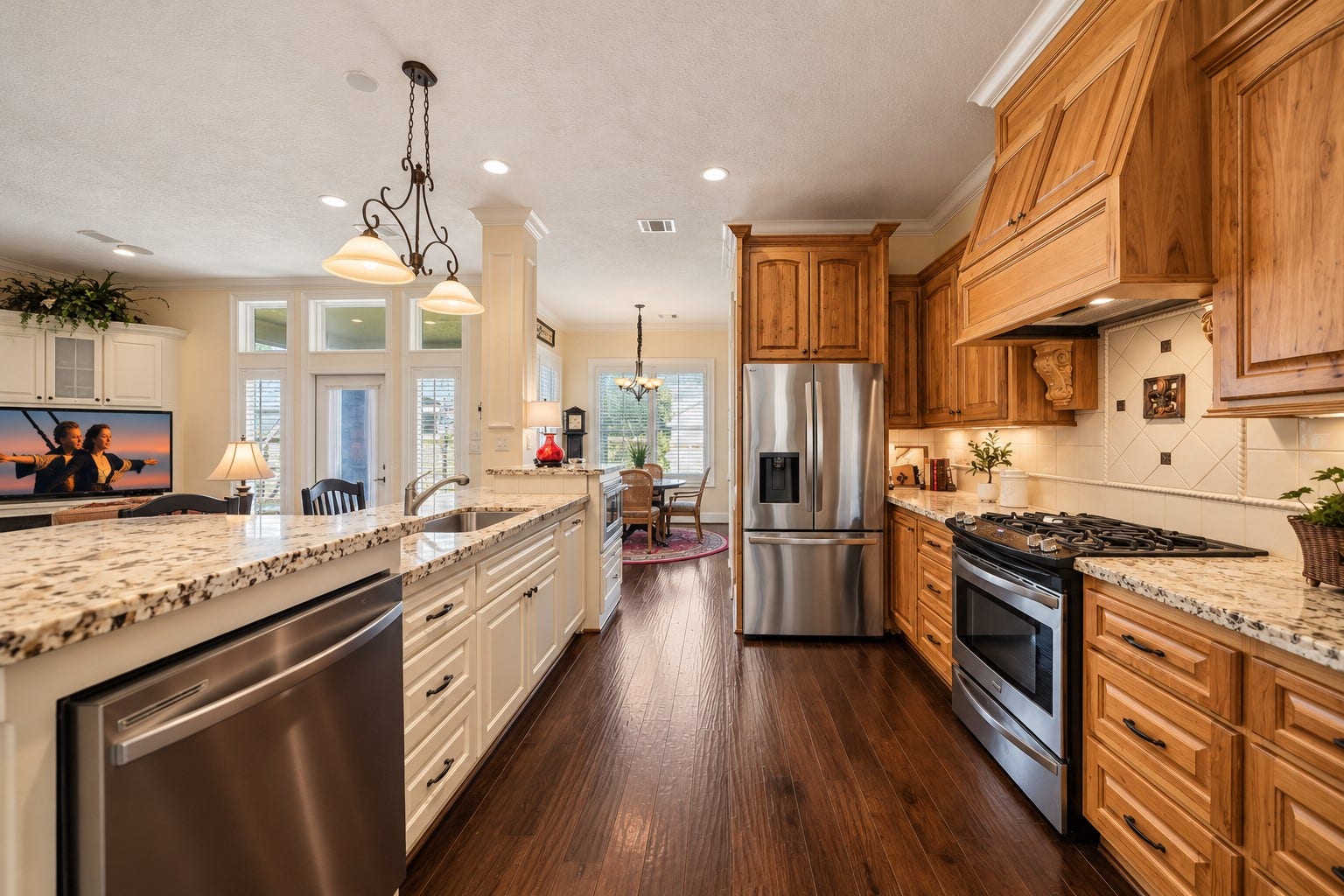 4631 Lake Village Drive, Fulshear, TX 77441 The home chef is sure to be inspired by this stunning Kitchen, where timeless design meets everyday functionality. Rich natural wood cabinetry is beautifully complemented by a contrasting white Island, while high-end granite countertops, a decorative tile backsplash, crown molding, and recessed lighting add layers of elegance and visual interest.