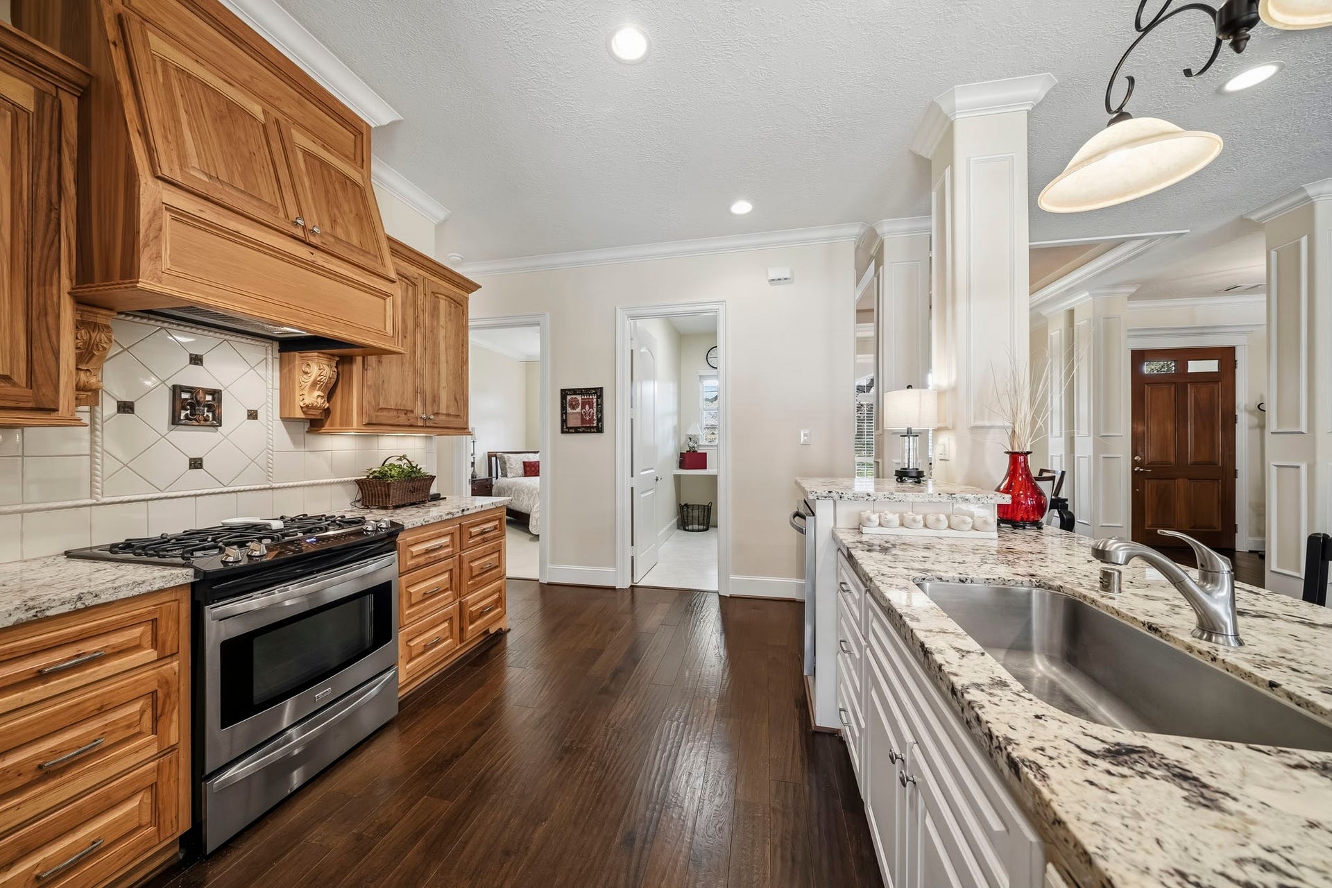 4631 Lake Village Drive, Fulshear, TX 77441 Complementing the Kitchen's timeless design is a suite of stainless-steel appliances, featuring a 4-burner gas range, built-in microwave, and whisper-quiet dishwasher. Combining professional-grade performance with sleek sophistication, this premium appliance package enhances both the beauty and functionality of the space.