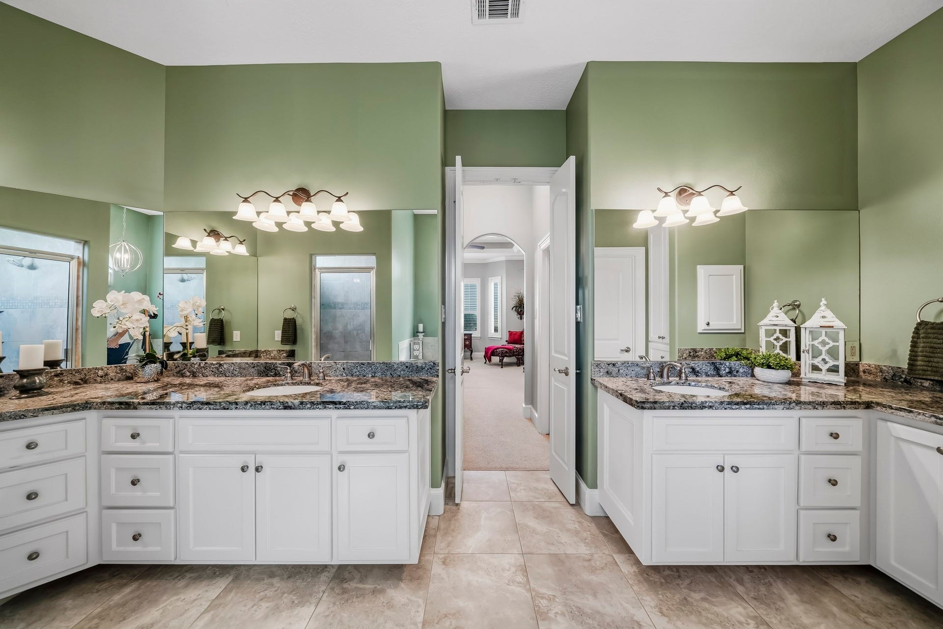 4631 Lake Village Drive, Fulshear, TX 77441 Thoughtfully designed for comfort and functionality, the dual vanities are beautifully finished with premium granite countertops, undermount sinks, extensive cabinetry, and a dedicated makeup vanity. Just beyond, a private hallway seamlessly connects the Primary Bedroom and Bathroom, where separate doors reveal expansive his & her walk-in closets, offering a boutique-inspired dressing experience and exceptional storage.