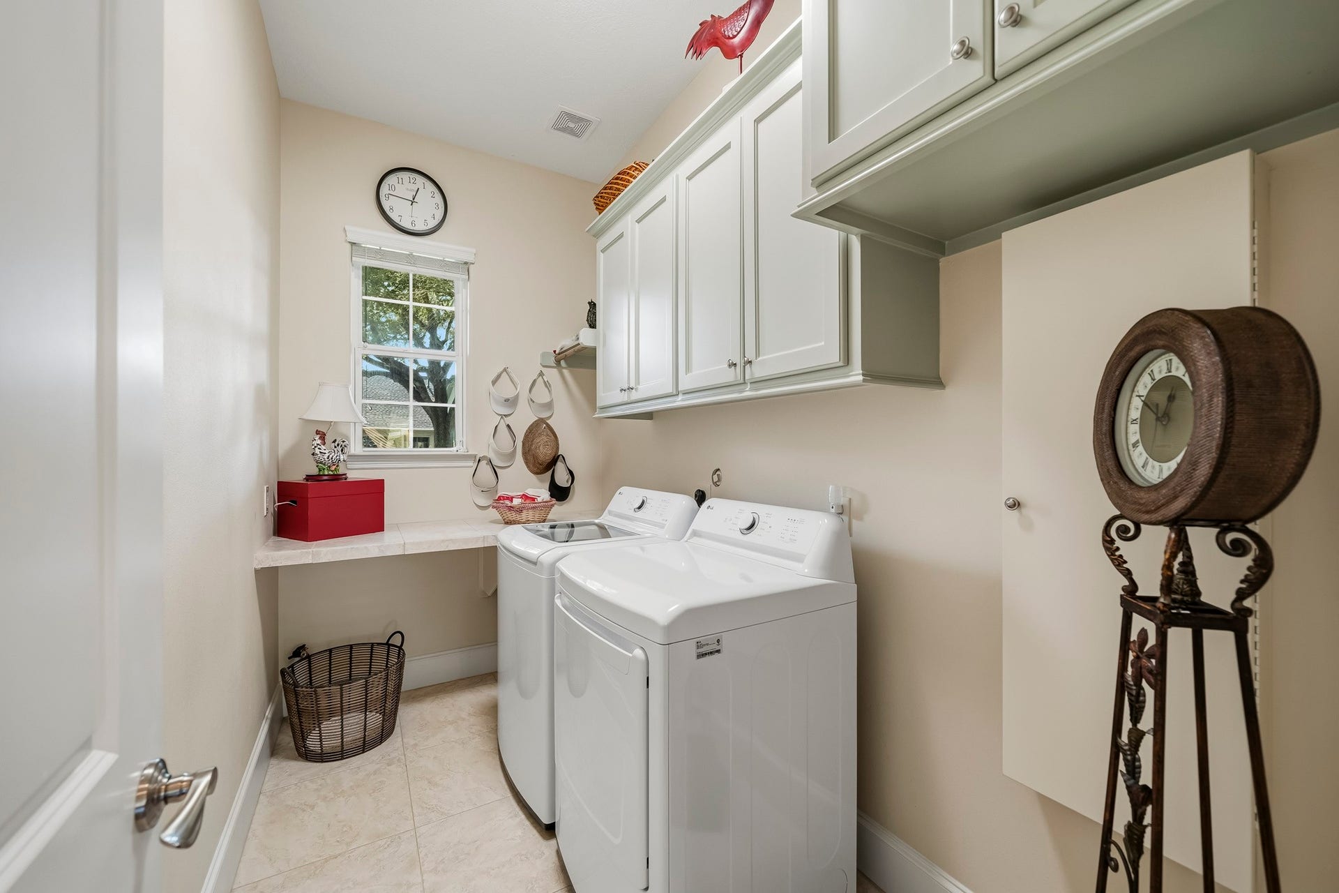 4631 Lake Village Drive, Fulshear, TX 77441 This thoughtfully designed Laundry Room transforms everyday chores into a more convenient experience. A spacious countertop provides the perfect area for sorting and folding, while overhead cabinetry keeps detergents, stain removers, and laundry essentials neatly organized and within easy reach. Completing the space is a built-in, pull-down ironing board, offering practical functionality without sacrificing valuable floor space.