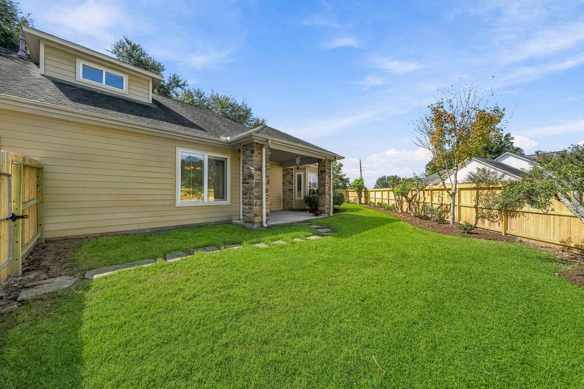 4631 Lake Village Drive, Fulshear, TX 77441 The Backyard offers a lush, green expanse that serves as a peaceful extension of the home's outdoor living space. A thoughtfully planted row of trees and shrubs is poised to mature into a beautiful natural privacy screen, providing additional shade, enhanced seclusion, and a serene backdrop for years to come.