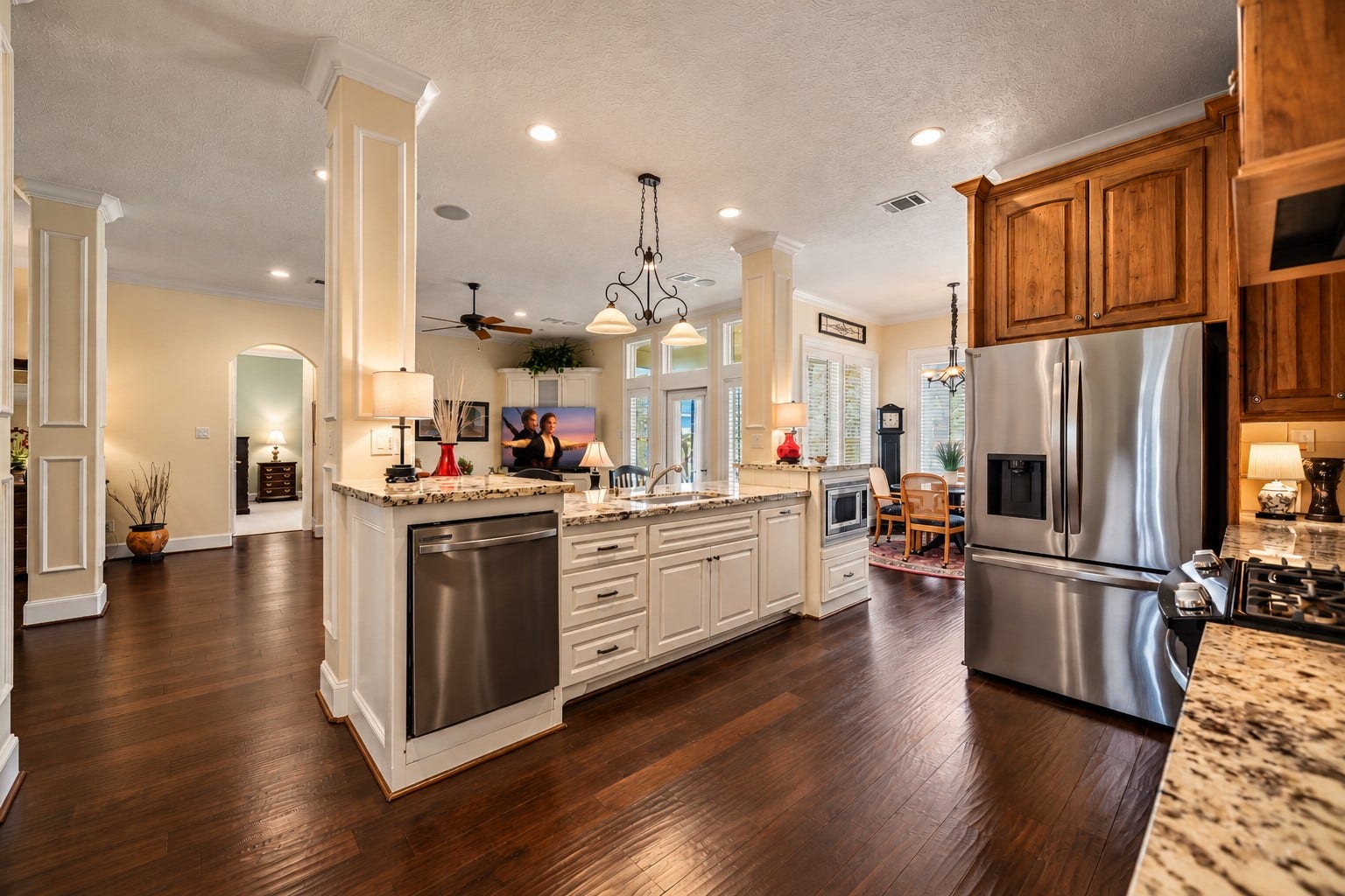 4631 Lake Village Drive, Fulshear, TX 77441 The Kitchen Island serves as both a stunning focal point and a highly functional workspace, framed by beautifully detailed pillars that add architectural character and distinction. An abundance of closed storage provides a place for everything, making it easy to maintain a clean, organized Kitchen. The undermount, single-basin, stainless steel sink is thoughtfully positioned to overlook the Family Room, allowing the home chef to stay connected to family, guests.