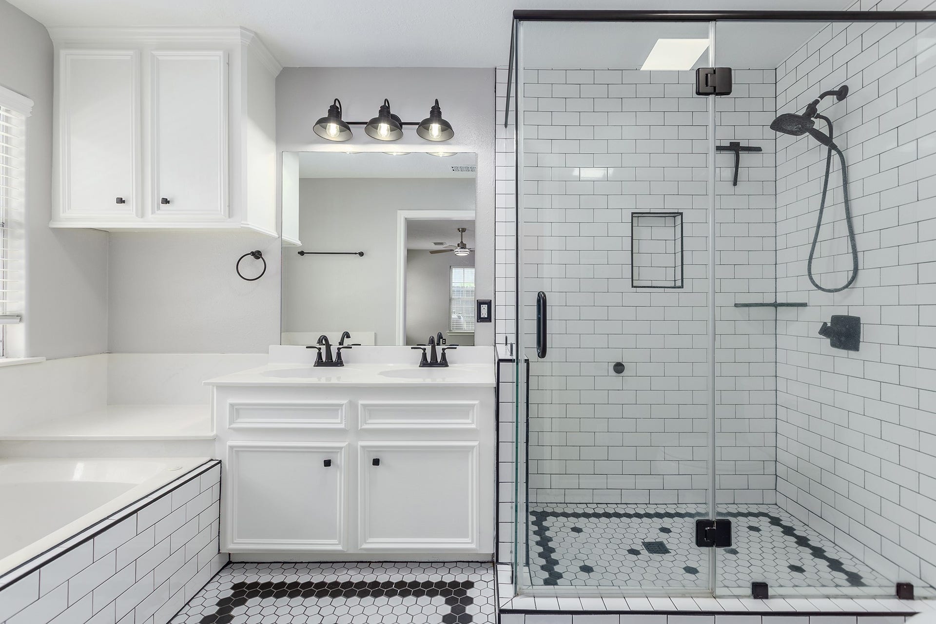 12830 Point Aquarius Boulevard, Willis, TX 77318 Custom tiled modern bathroom with double sinks, tons of storage and soaker bathtub.