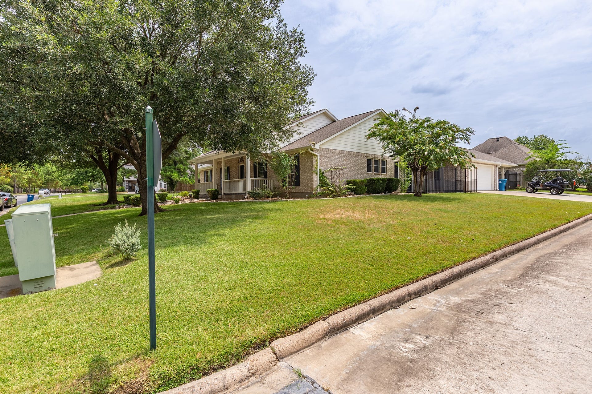 12830 Point Aquarius Boulevard, Willis, TX 77318 Great sized front yard and covered patio with mature trees and landscaping.