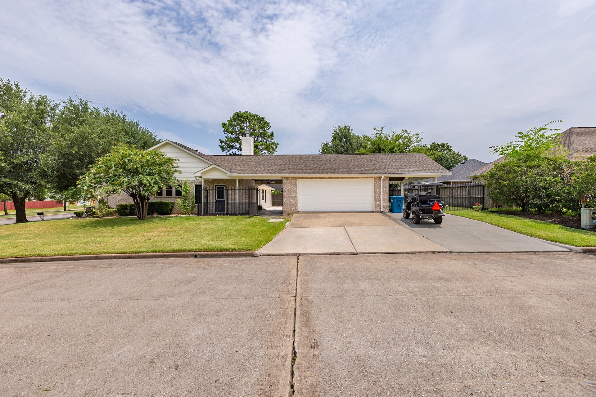 12830 Point Aquarius Boulevard, Willis, TX 77318 Extra wide driveway to additional parking. Side view of the corner lot.