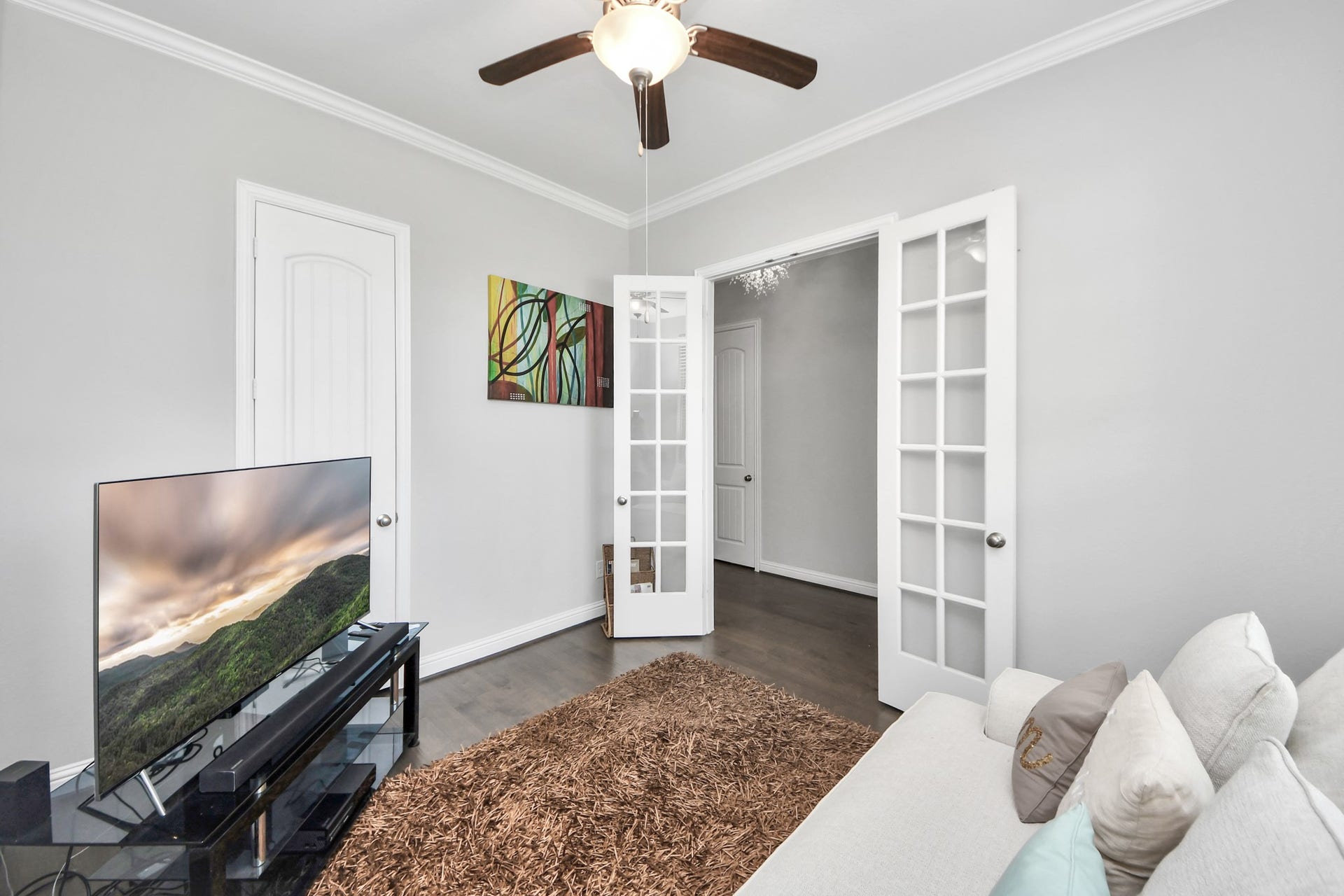 Experience versatility in this inviting space, perfect as a cozy study or an exciting game room, complete with stylish French doors and modern finishes.