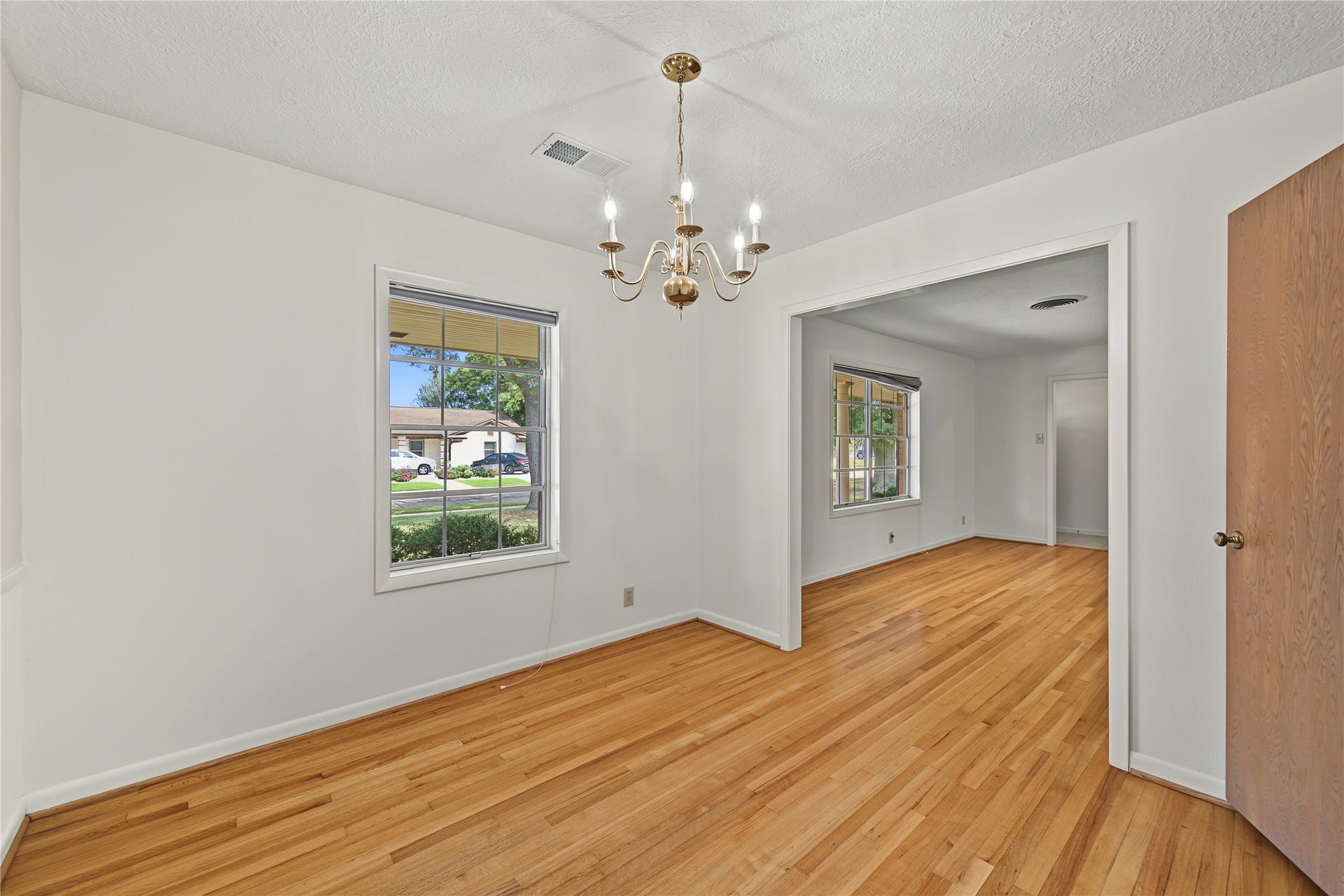 VIEW OF THE FORMAL DINING ROOM THAT OPENS UP TO THE FORMAL LIVING ROOM