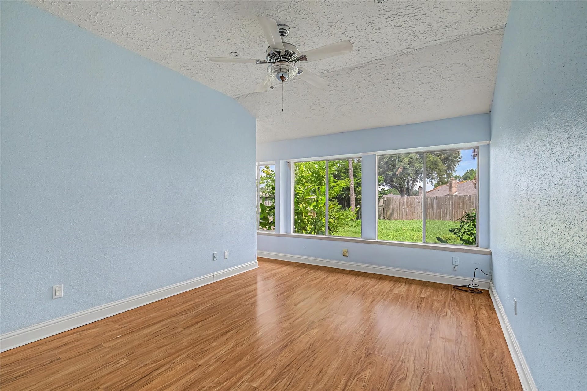 14218 Whitecross Drive, Houston, TX 77083 Spacious primary bedroom featuring a scenic view of the rear garden.