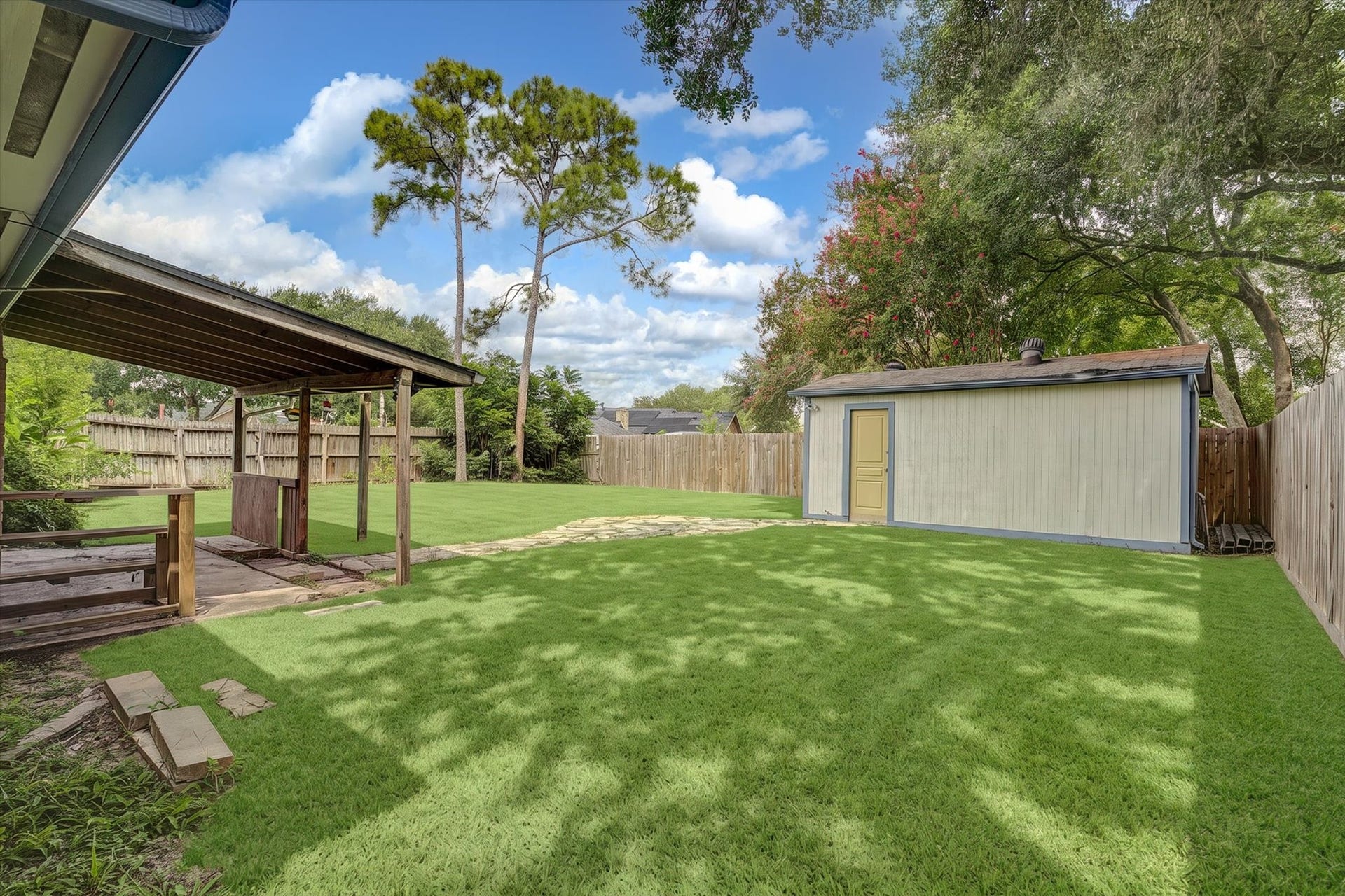 14218 Whitecross Drive, Houston, TX 77083 This backyard storage shed provides convenient space for equipment, allowing for better organization and additional room in the garage.