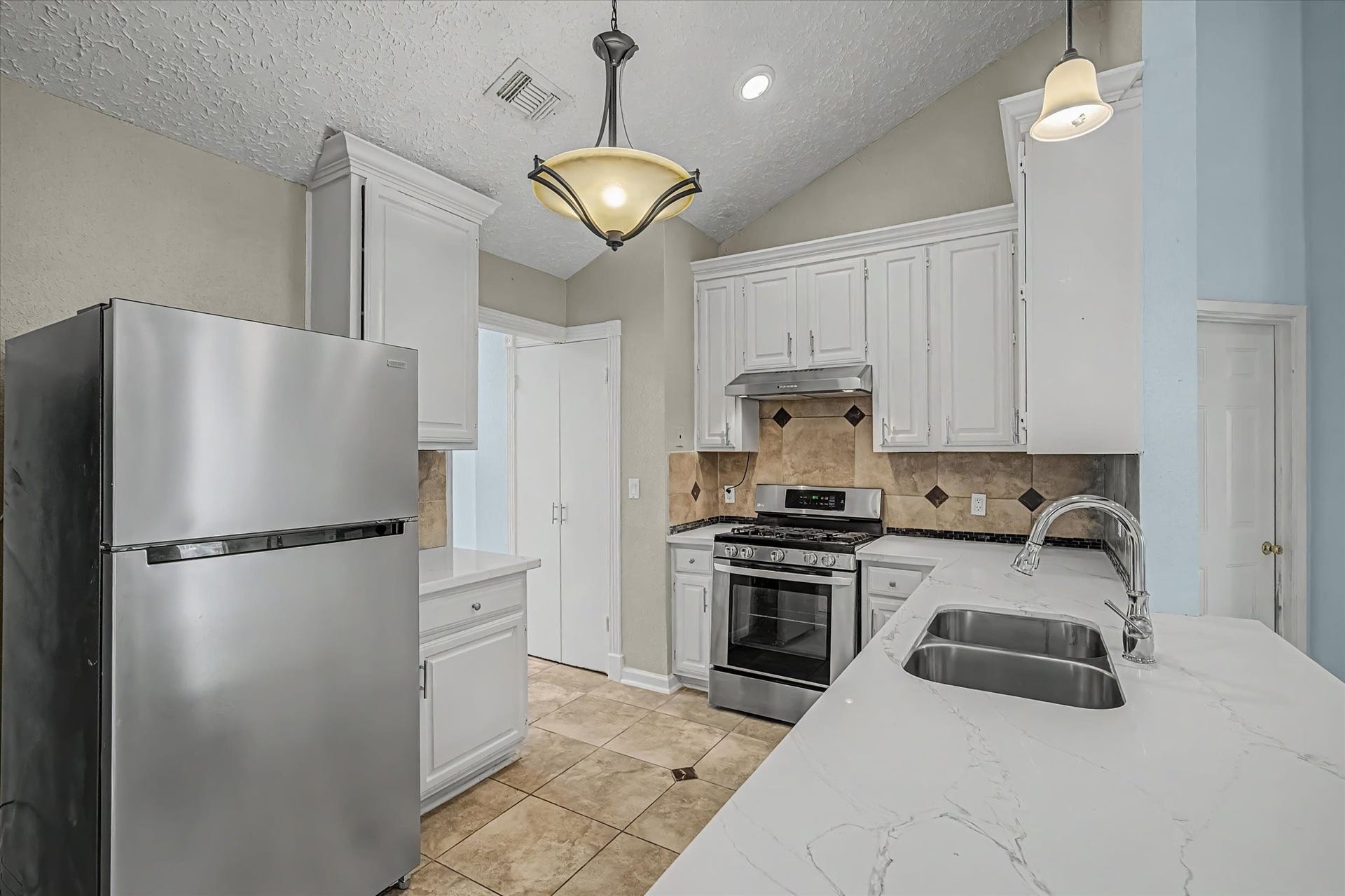 14218 Whitecross Drive, Houston, TX 77083 The kitchen features stainless steel appliances, and the refrigerator is included with the sale of the home.