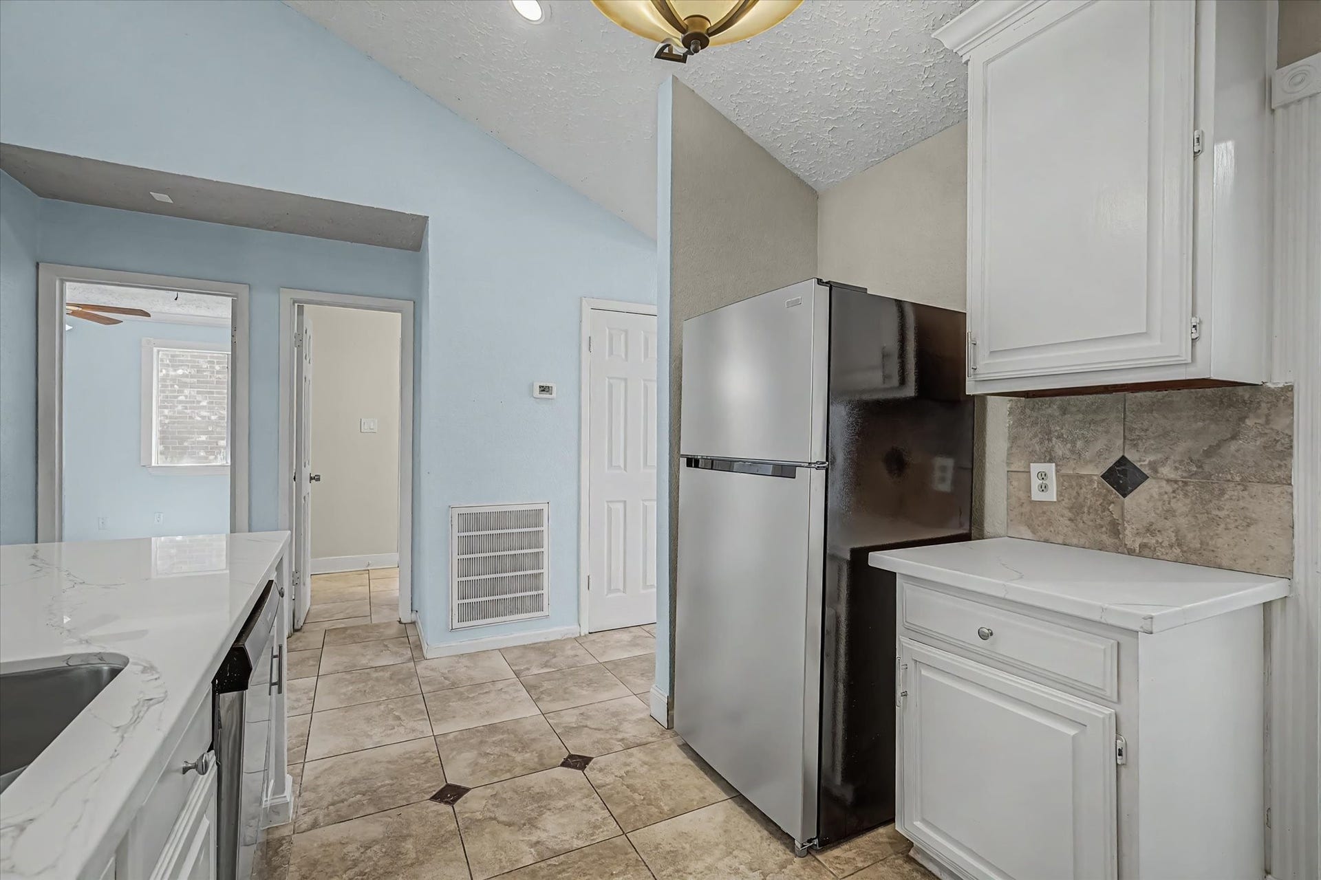 14218 Whitecross Drive, Houston, TX 77083 Kitchen offers an abundance of cabinetry, providing ample storage space.