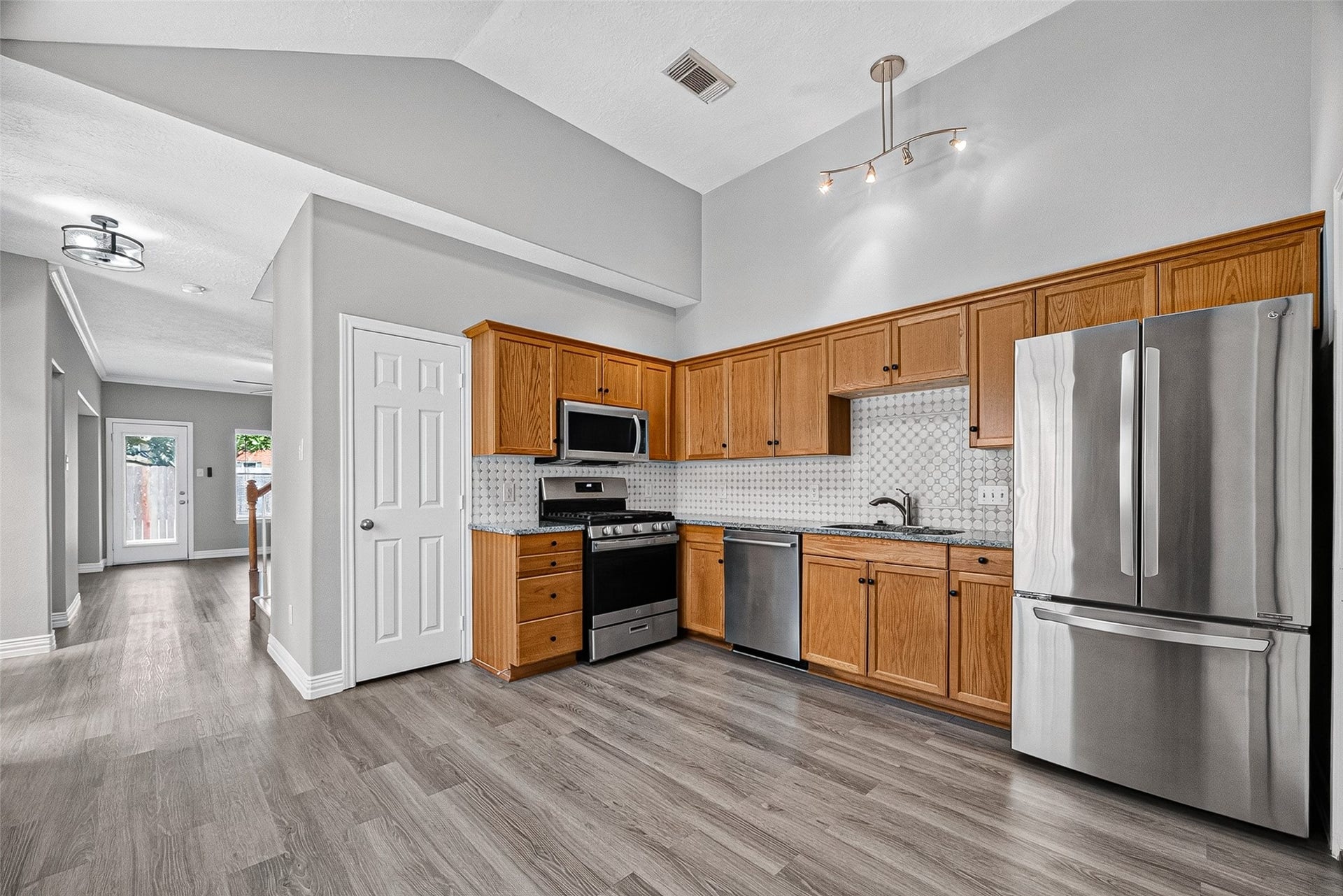 2034 Glencove Drive, Seabrook, TX 77586 Kitchen features a stainless fridge, range, and ample counters