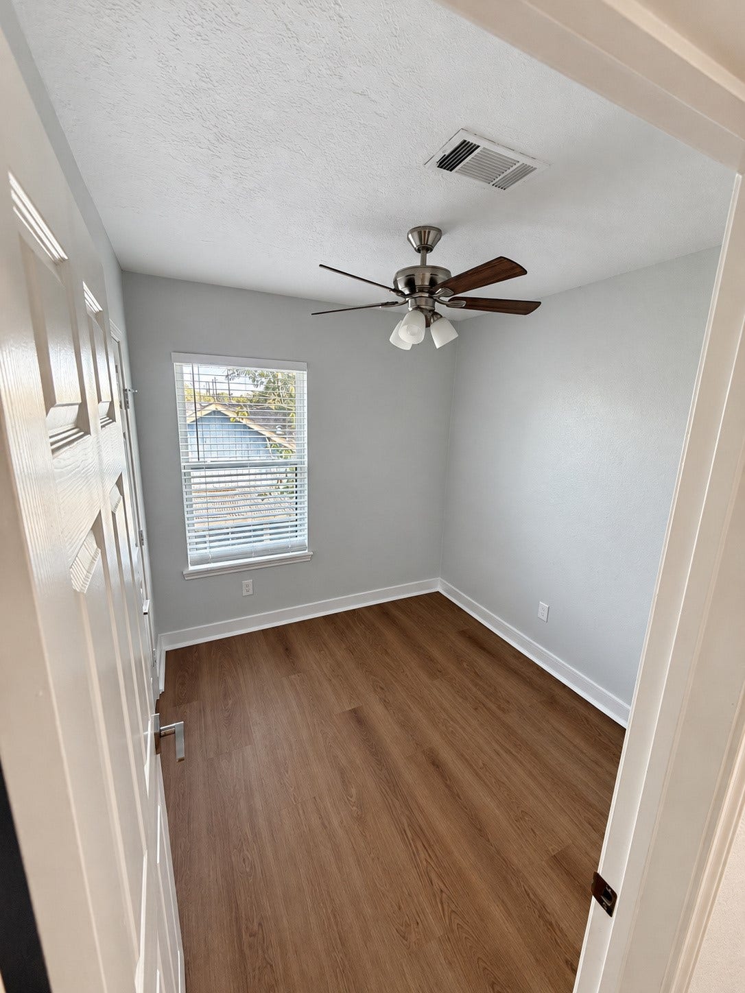 Compact second bedroom offers flexibility for use as a home office or study.