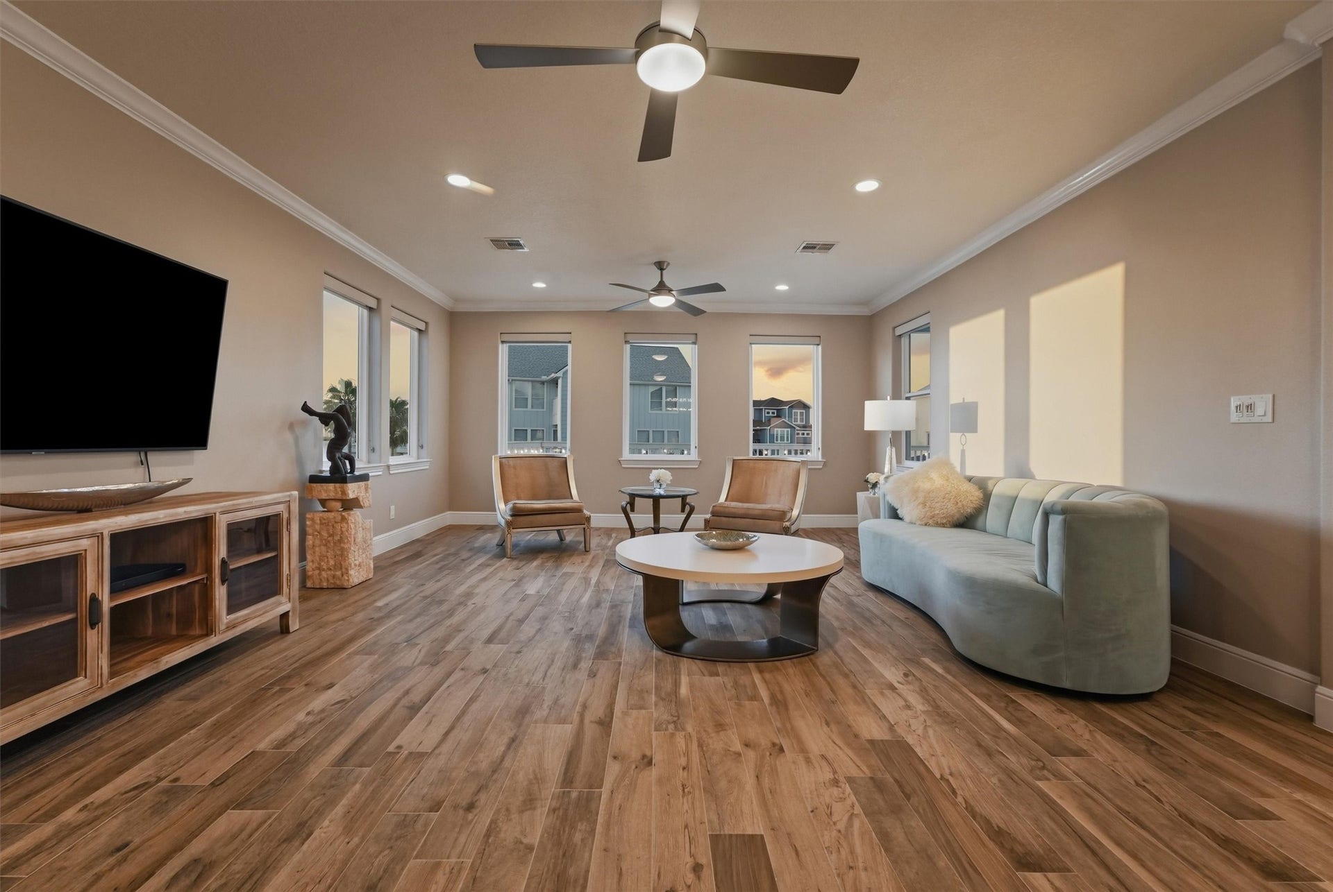 438 Amanda Circle, Tiki Island, TX 77554 Golden sunset light pours into the main living area, creating a warm, relaxed atmosphere that feels perfectly suited for unwinding at the end of the day.