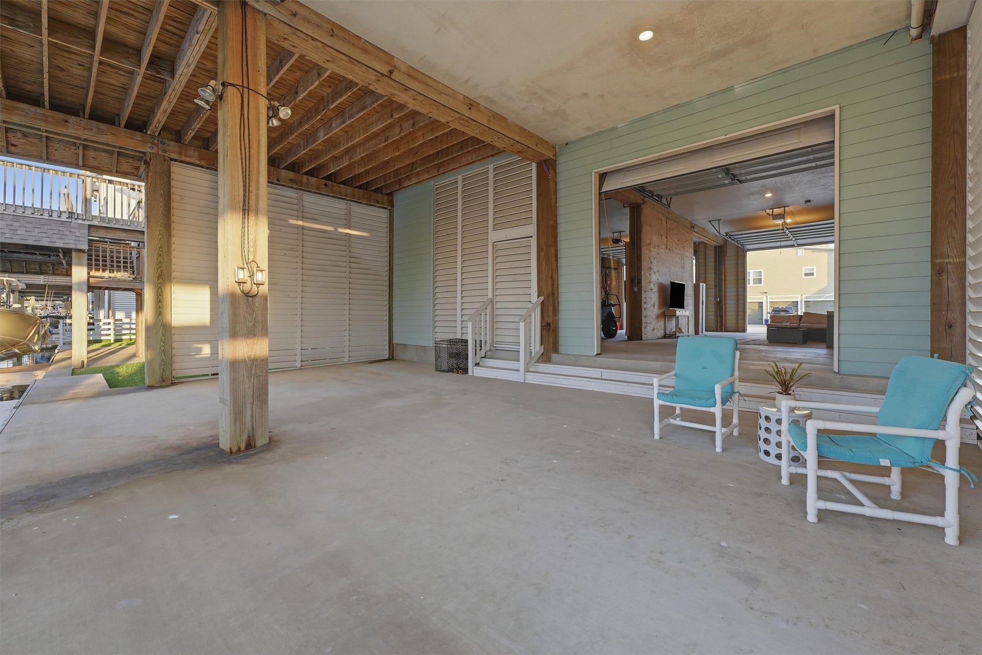 438 Amanda Circle, Tiki Island, TX 77554 The covered ground-level patio expands the homes entertaining space with plenty of room to dine, lounge, and gather just steps from the canal, dock, and boat slip.