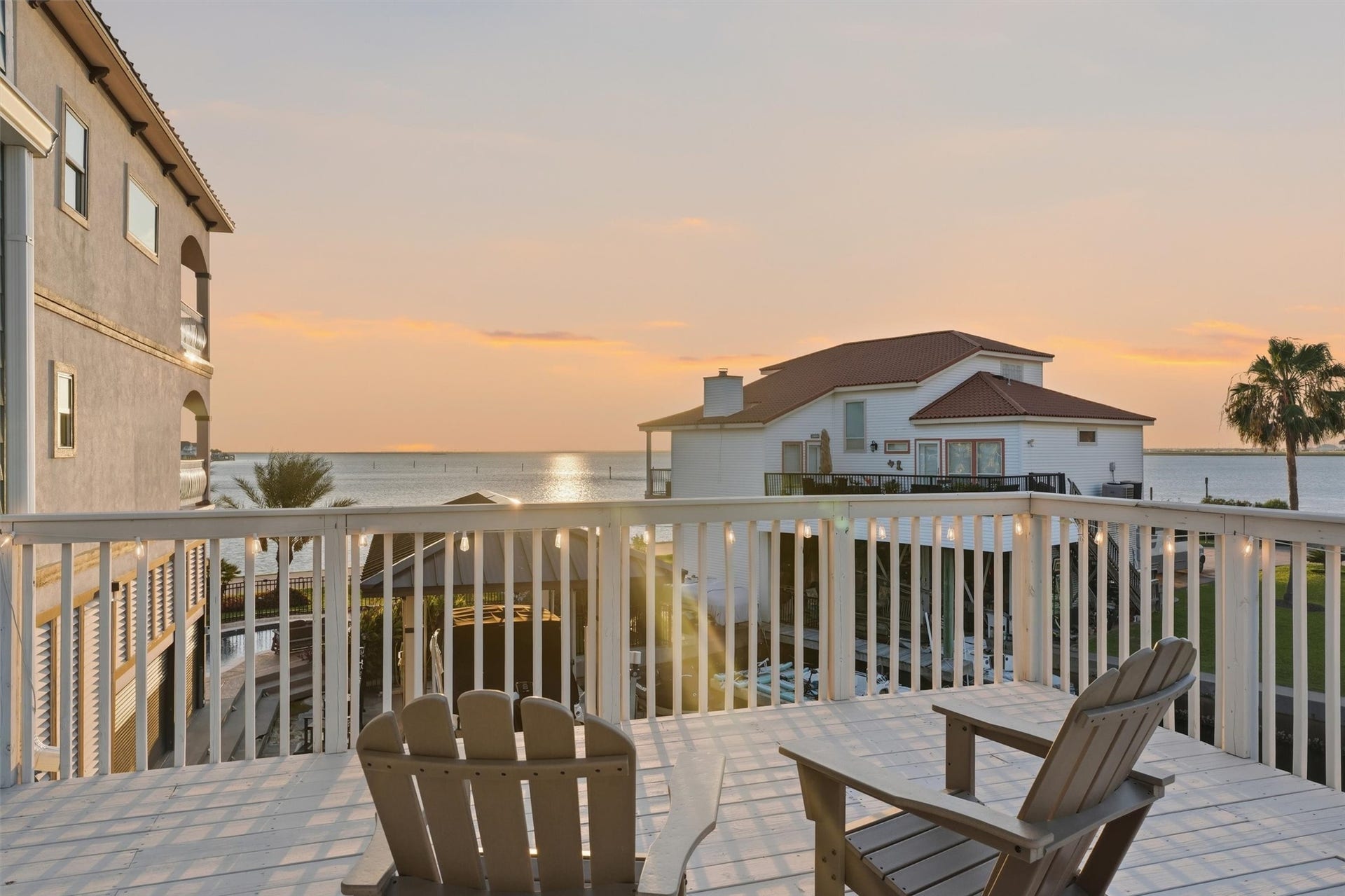 438 Amanda Circle, Tiki Island, TX 77554 Pull up a chair and enjoy peaceful canal views from the spacious main-level balcony, where everyday moments feel more relaxed against a beautiful waterfront backdrop.