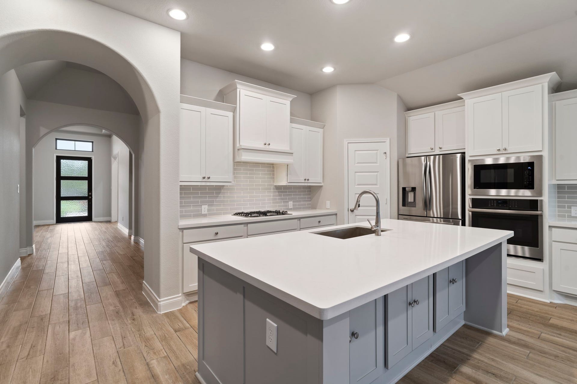 2315 Calm Channel Court, Missouri City, TX 77459 A corner walk-in pantry, generous counter space, and an island with built-in seating make this kitchen both functional and inviting.