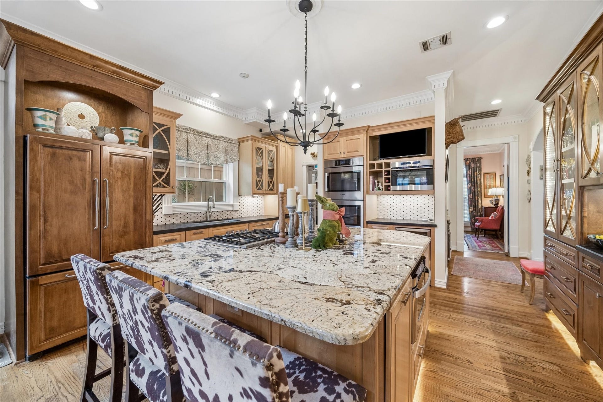 2120 Potomac Drive, #A, Houston, TX 77057 Kitchen also features two Bosch convection ovens, Bosch warming drawer, Wolf steam convection oven, and a Danby wine refrigerator. To the right is a gorgeous armoire piece that allows for plenty of storage. Island and armoire both feature lighting underneath!