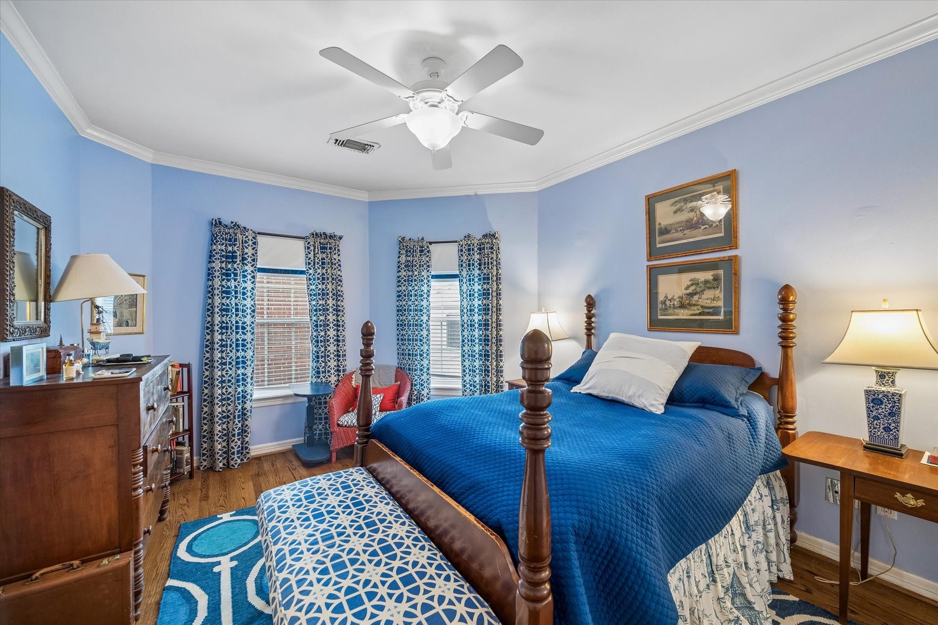 2120 Potomac Drive, #A, Houston, TX 77057 This secondary bedroom features an airy light blue walls, large closet, an en-suite bathroom, hardwood floors, and crown molding.