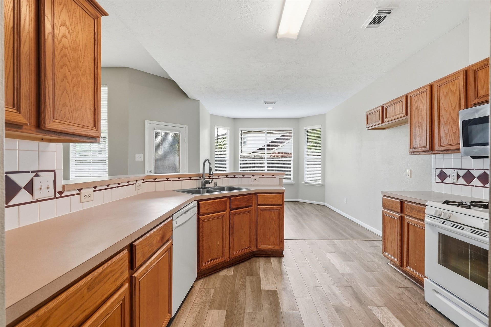 3003 Grey Mist Court, Friendswood, TX 77546 Kitchen featuring ample cabinetry, counter space and natural light