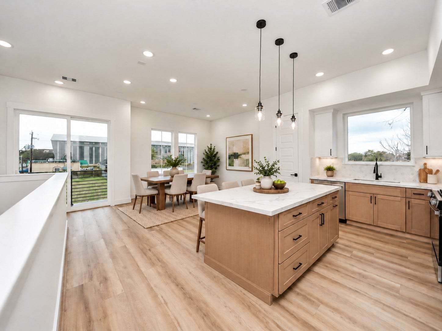 Virtually staged second-floor dining area featuring an open-concept layout, spacious kitchen with oversized island, large windows, and balcony access.