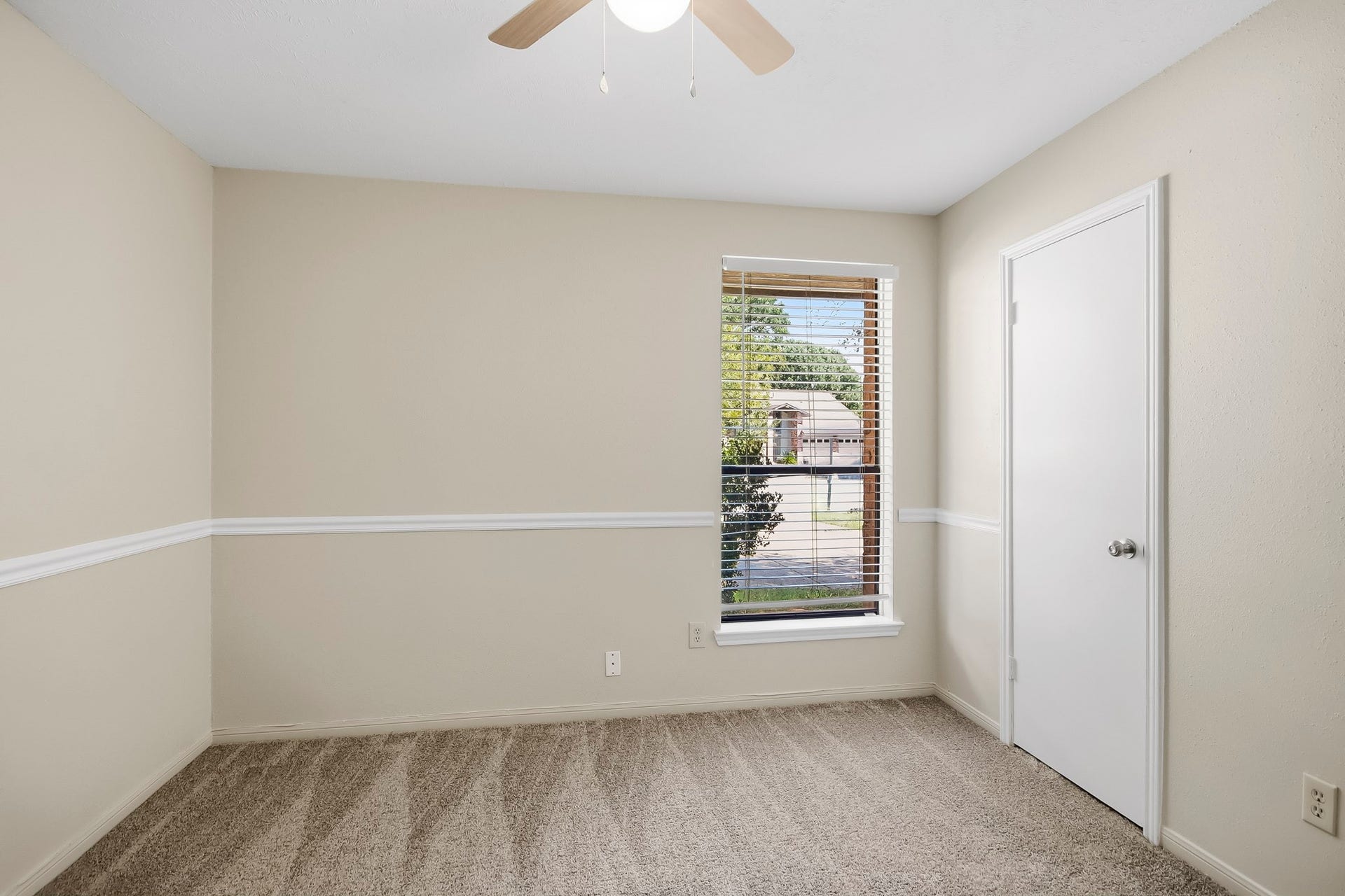 8807 Lakeside Forest Drive, Houston, TX 77088 Third bedroom featuring carpet flooring, a ceiling fan, and a window providing natural light.