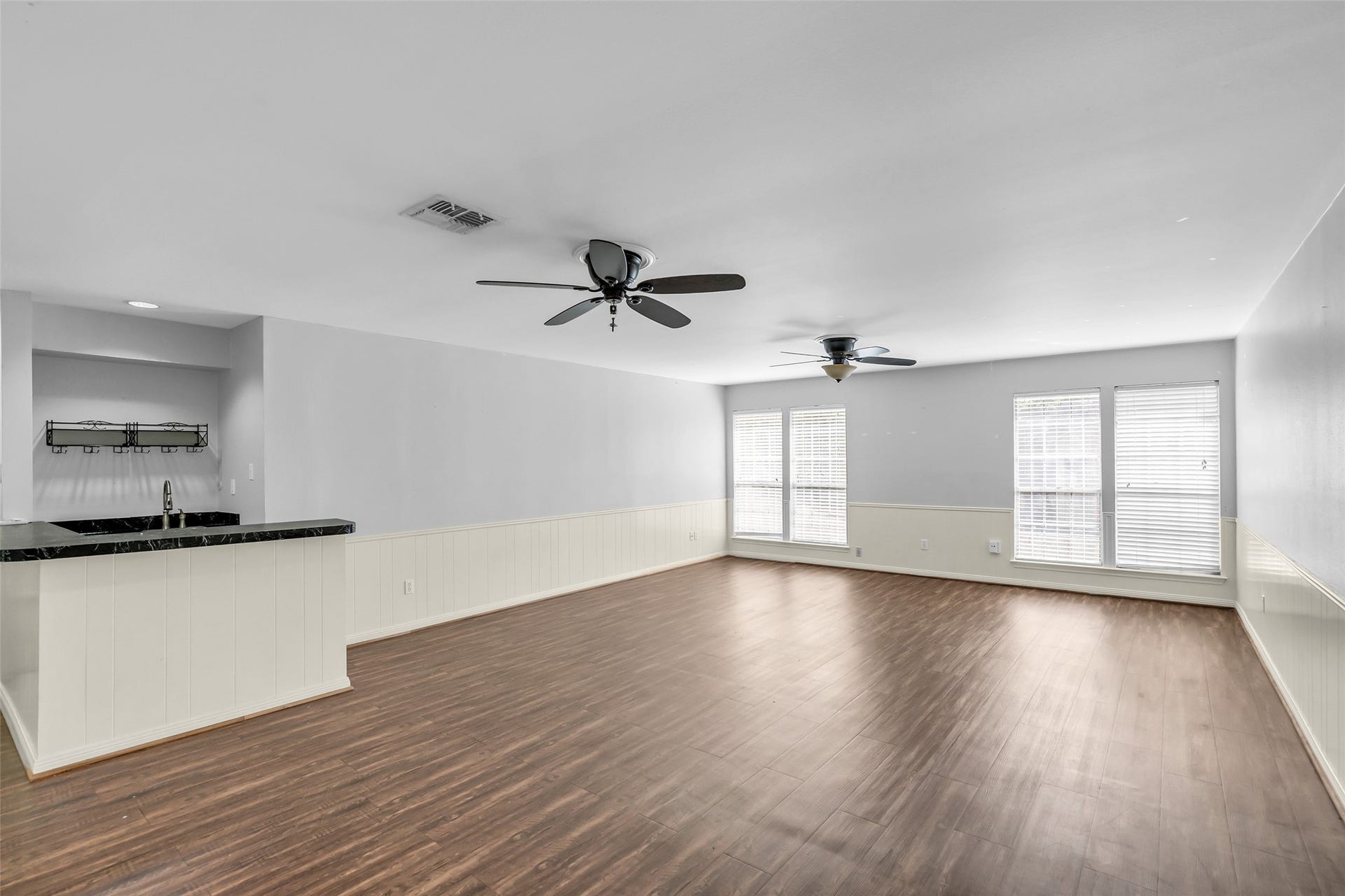 14014 Court Of Regents, Houston, TX 77069 Spacious flex room on the second floor overlooking the backyard, suitable for a game room or sitting area, and equipped with a built-in counter and sink for added convenience.