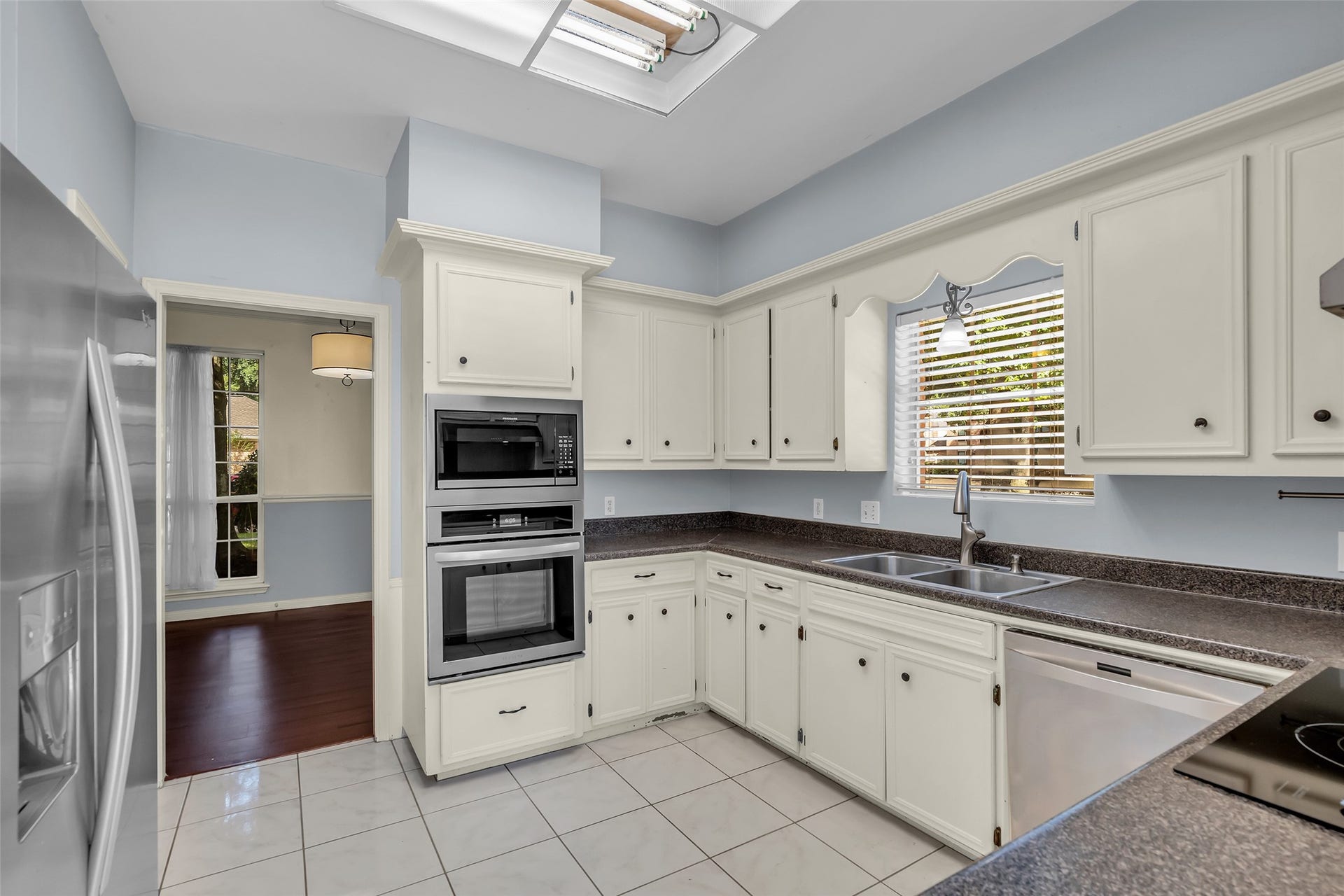 14014 Court Of Regents, Houston, TX 77069 This full view of the kitchen showcases its functional layout and ample cabinet space for storage.