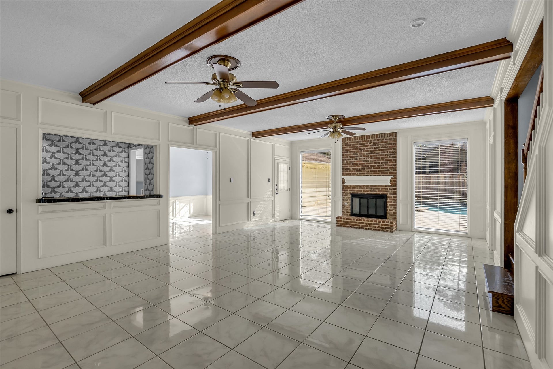 14014 Court Of Regents, Houston, TX 77069 A wet bar is conveniently located to the side, and windows along the back overlook the pool, bringing in plenty of natural light.