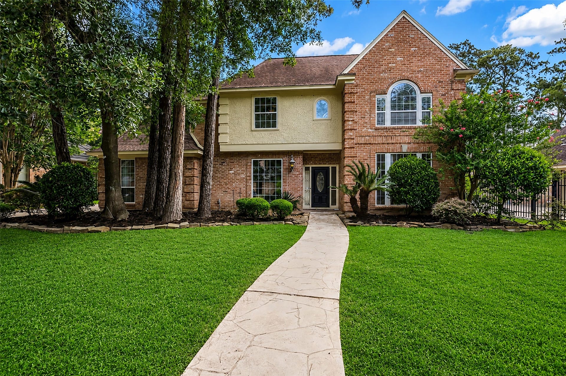 14014 Court Of Regents, Houston, TX 77069 This charming home makes a great first impression with its attractive brick and wood exterior, inviting curb appeal, and timeless character.