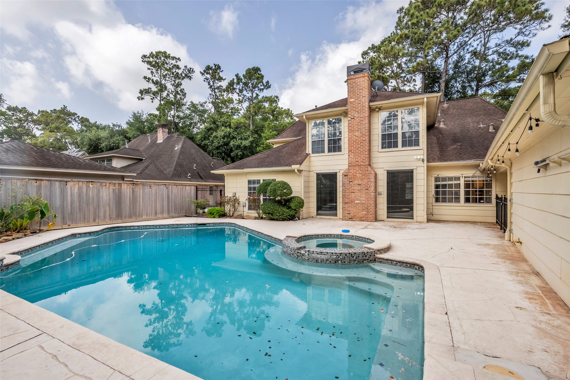 14014 Court Of Regents, Houston, TX 77069 View of the rear of the home with a fully fenced backyard, providing privacy and a defined outdoor space.