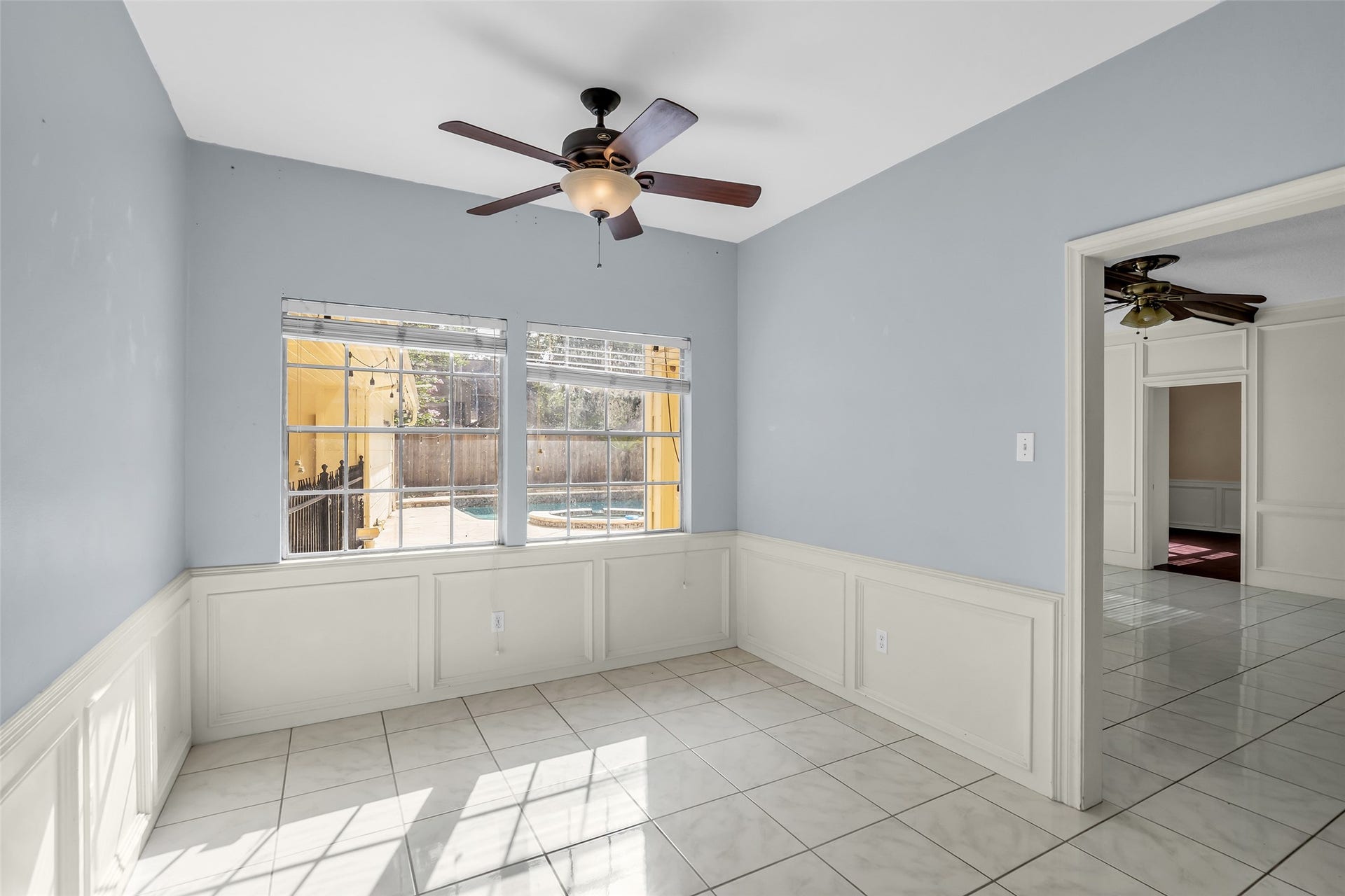14014 Court Of Regents, Houston, TX 77069 The breakfast nook is bright and welcoming, with large windows that bring in plenty of natural light while overlooking the backyard pool.