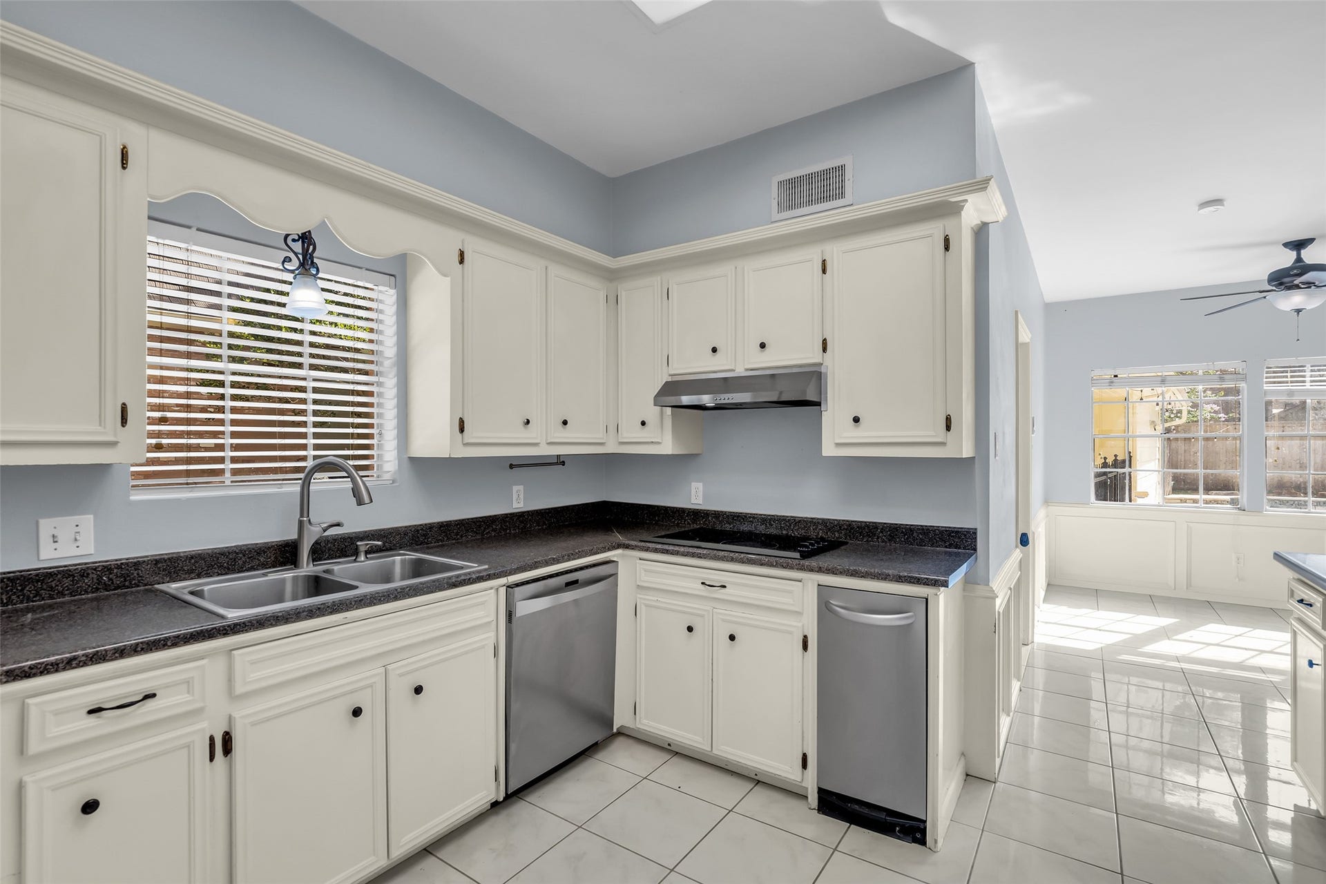 14014 Court Of Regents, Houston, TX 77069 The kitchen is equipped with stainless steel appliances, including a dishwasher, disposal, microwave, double oven, electric cooktop, and compactor.