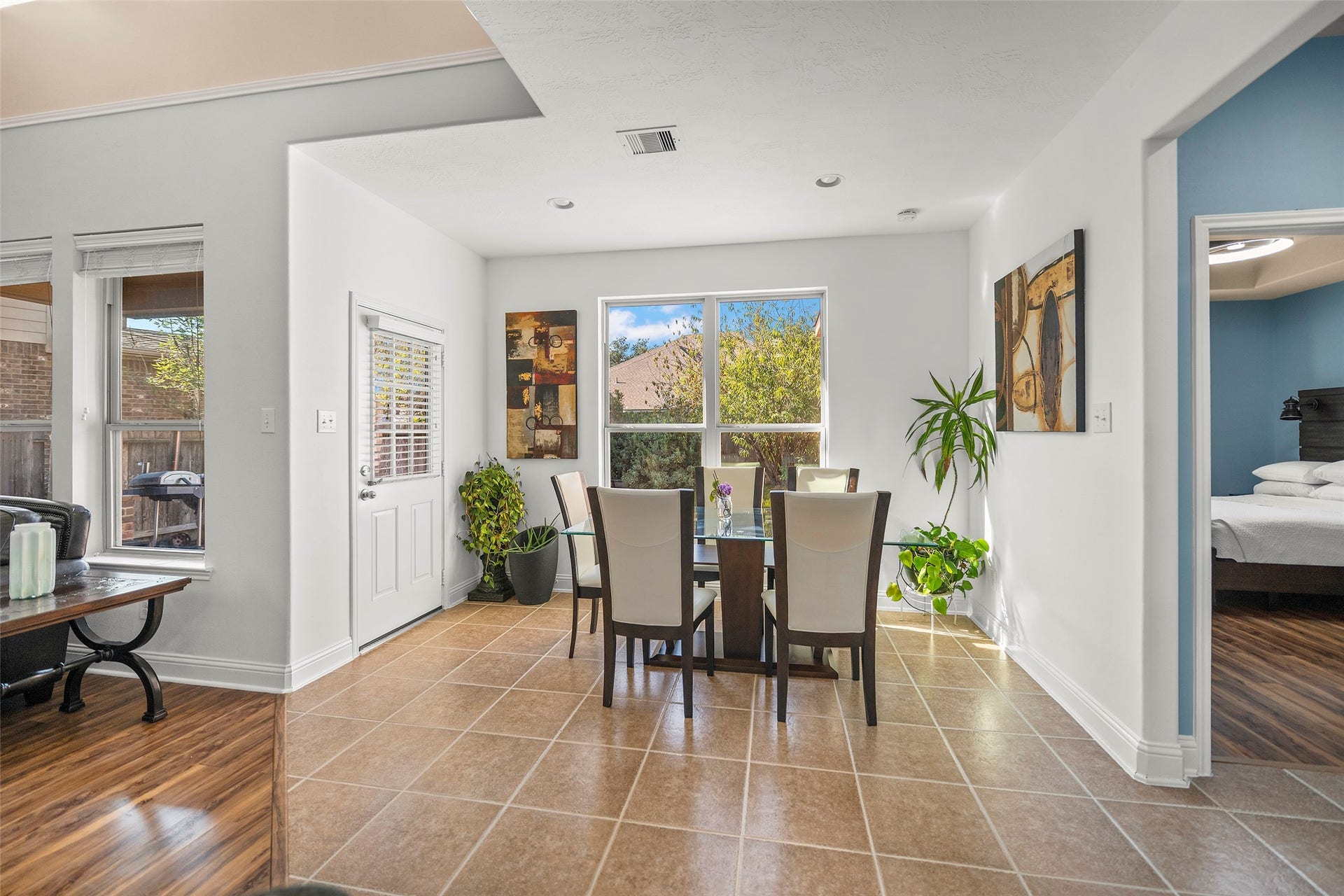 Spacious breakfast room featuring an abundance of natural light and ample space for a six-person dining table.