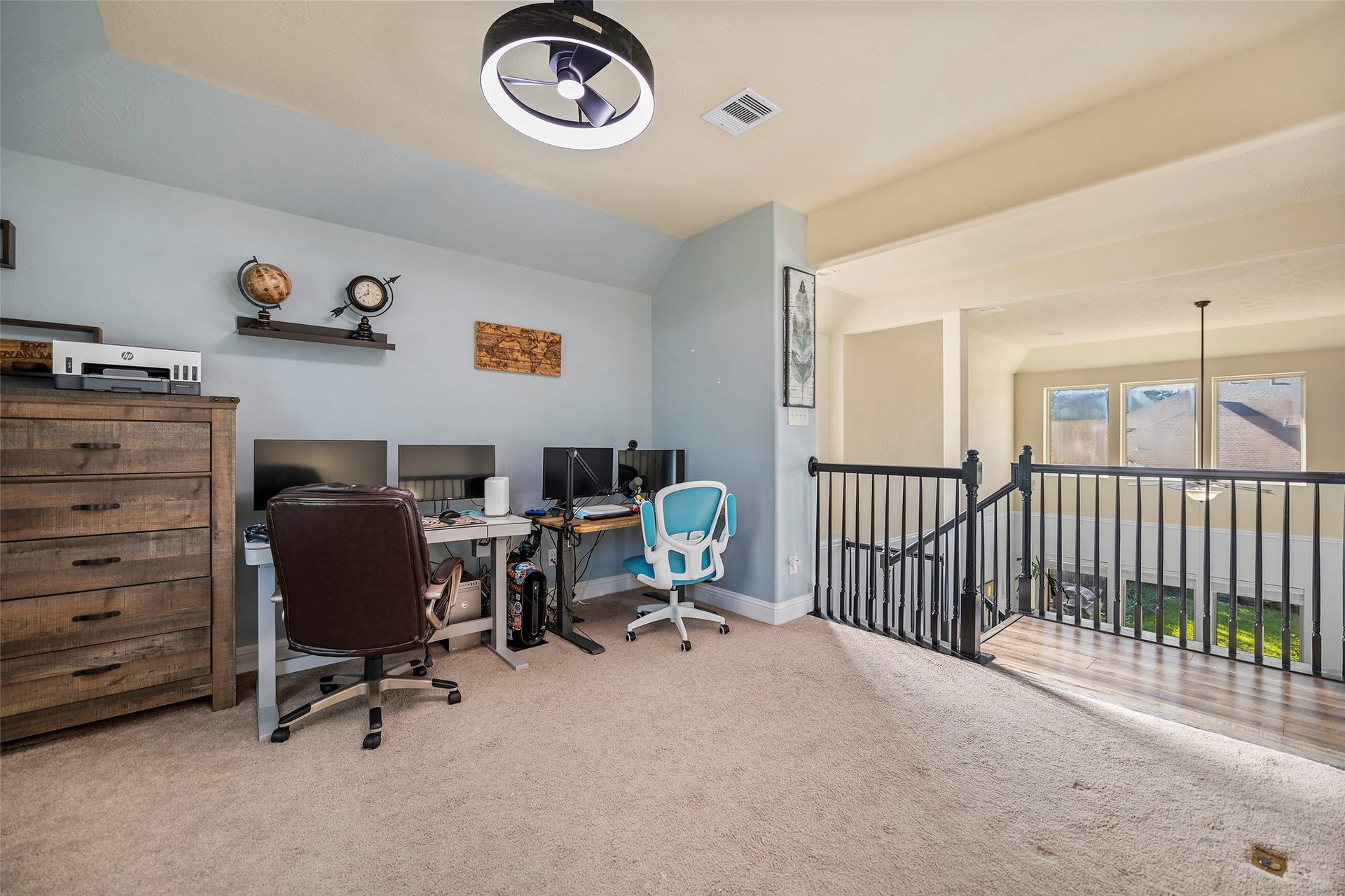 This versatile space is currently utilized as a home office but offers the flexibility to serve as a spacious game room.