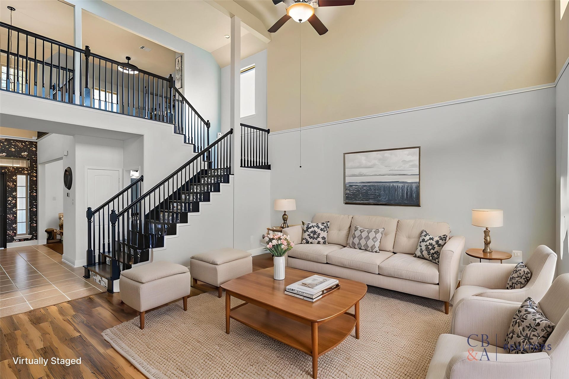 Spacious living room featuring double-height ceilings, abundant natural light, and beautiful hardwood floors. Note: furniture shown is virtual staging intended to showcase the potential of the space.