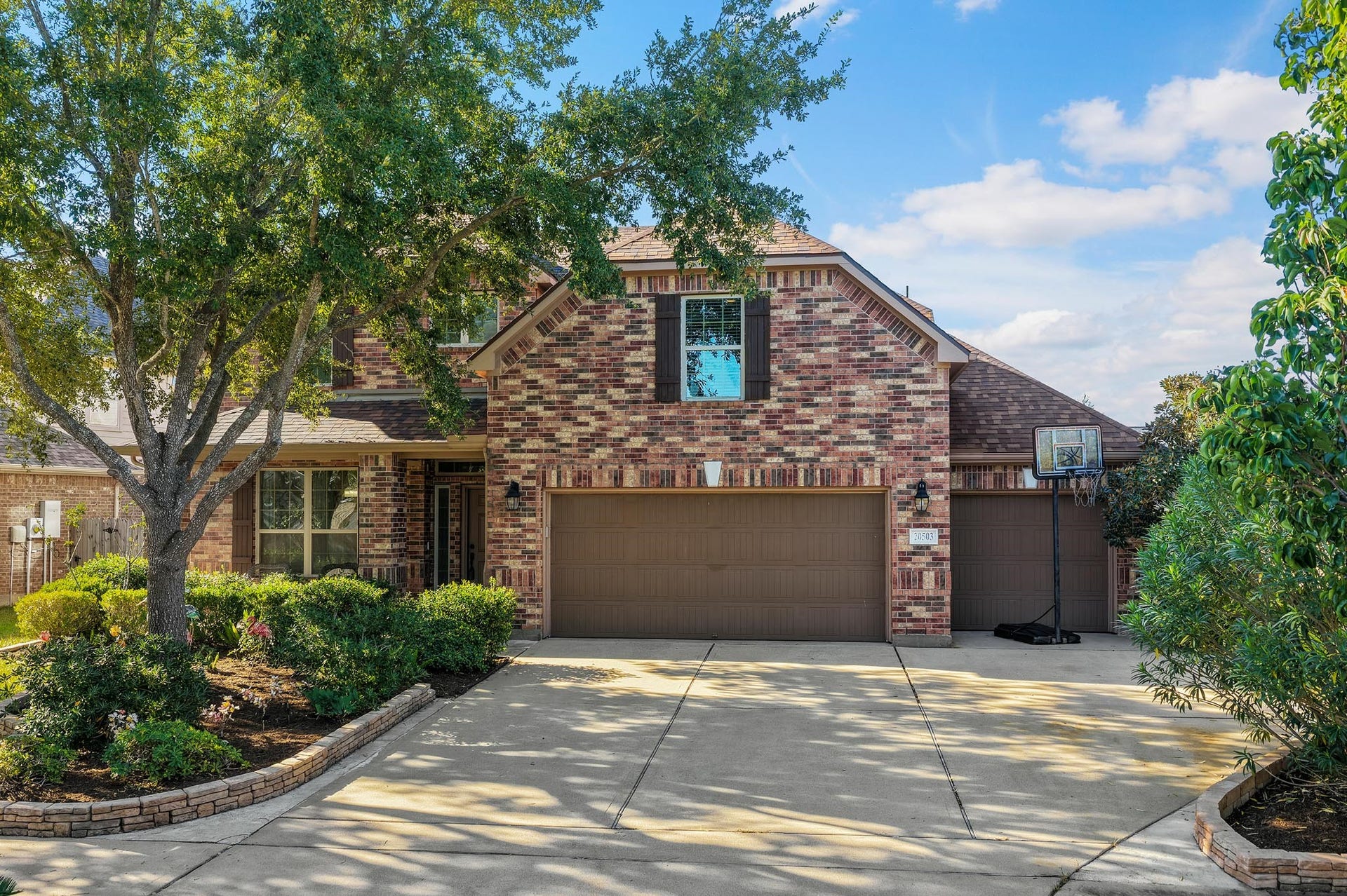 Spacious 3-car garage featuring durable epoxy flooring, a convenient utility sink, and direct access to the backyard.
