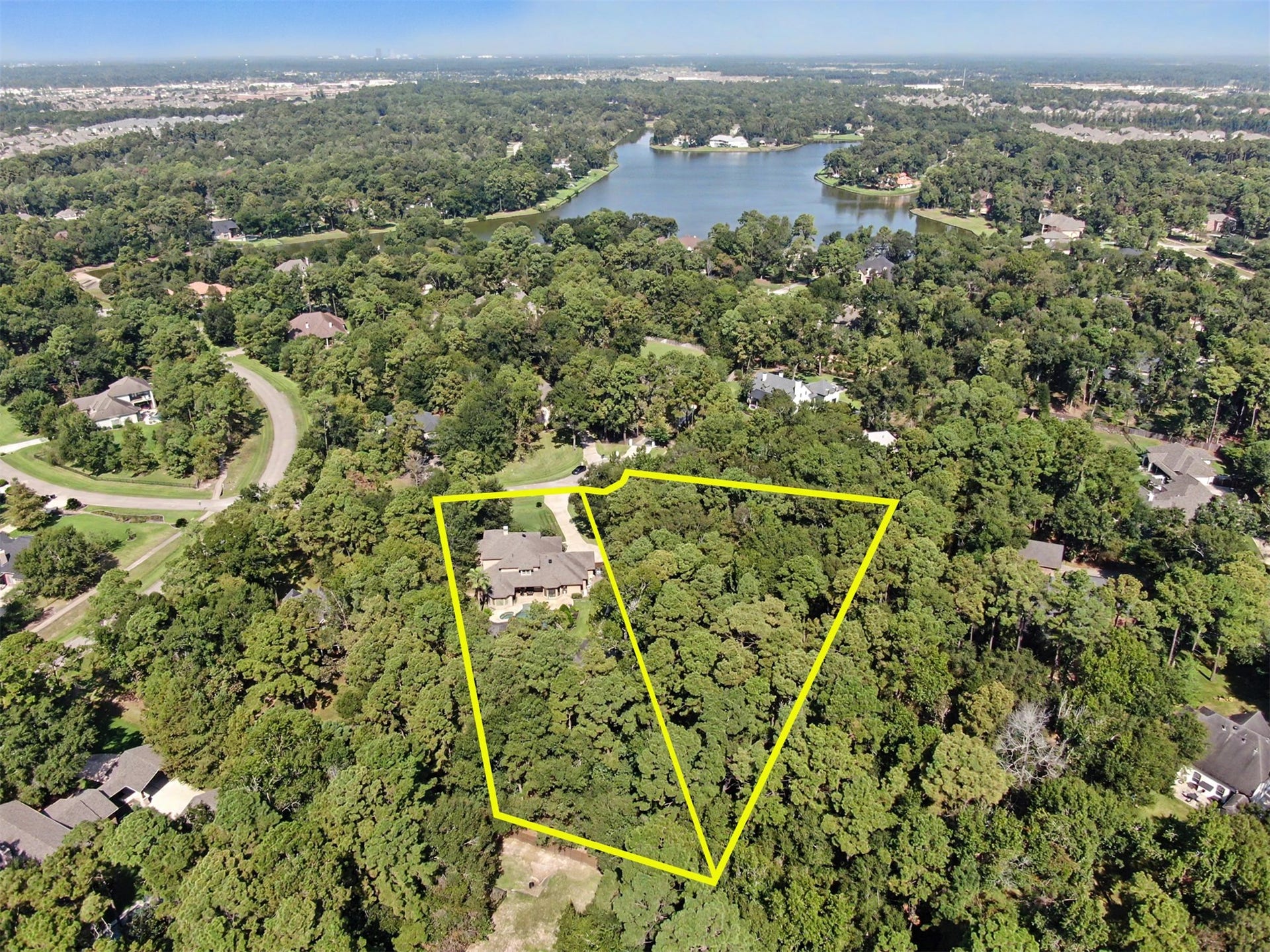 27706 Braydon Court, Spring, TX 77386 Expansive wooded property offering privacy and serene lake views, nestled in a picturesque neighborhood.