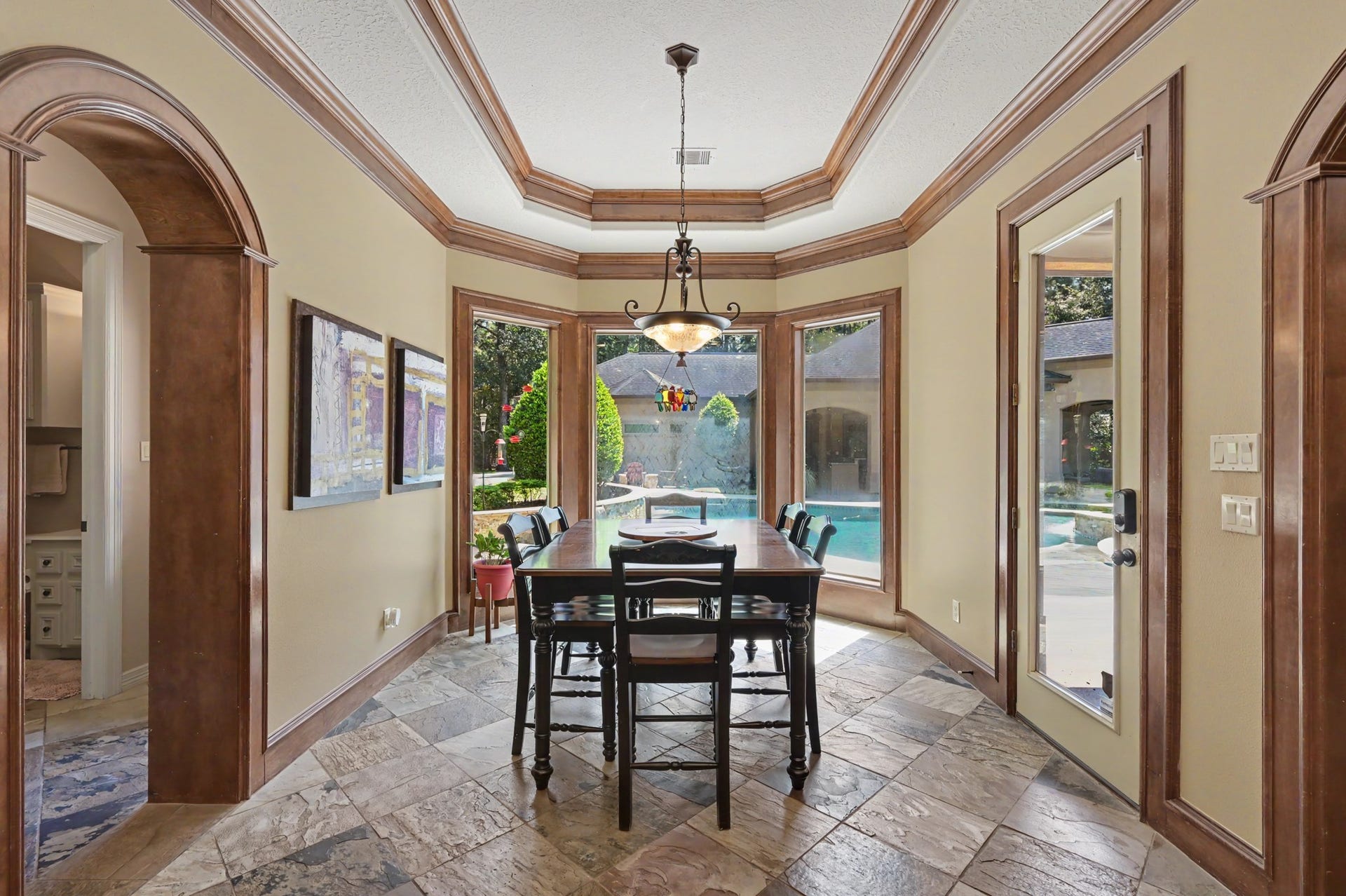 27706 Braydon Court, Spring, TX 77386 Breakfast area, just off the kitchen, with rich wood accents and large windows offering views of the pool, creating a bright and inviting atmosphere.