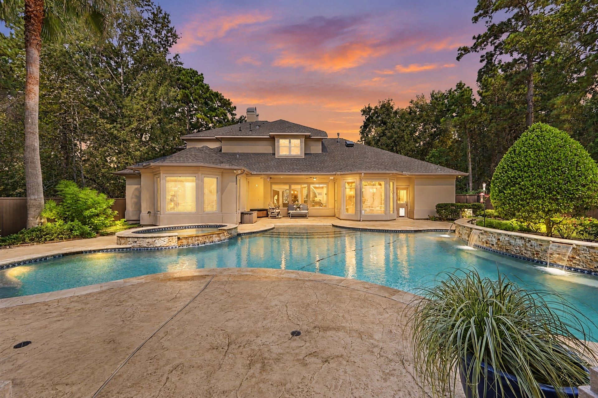27706 Braydon Court, Spring, TX 77386 Luxurious backyard oasis featuring a sparkling pool, elegant spa, and beautifully landscaped surroundings, perfect for entertaining and relaxation.
